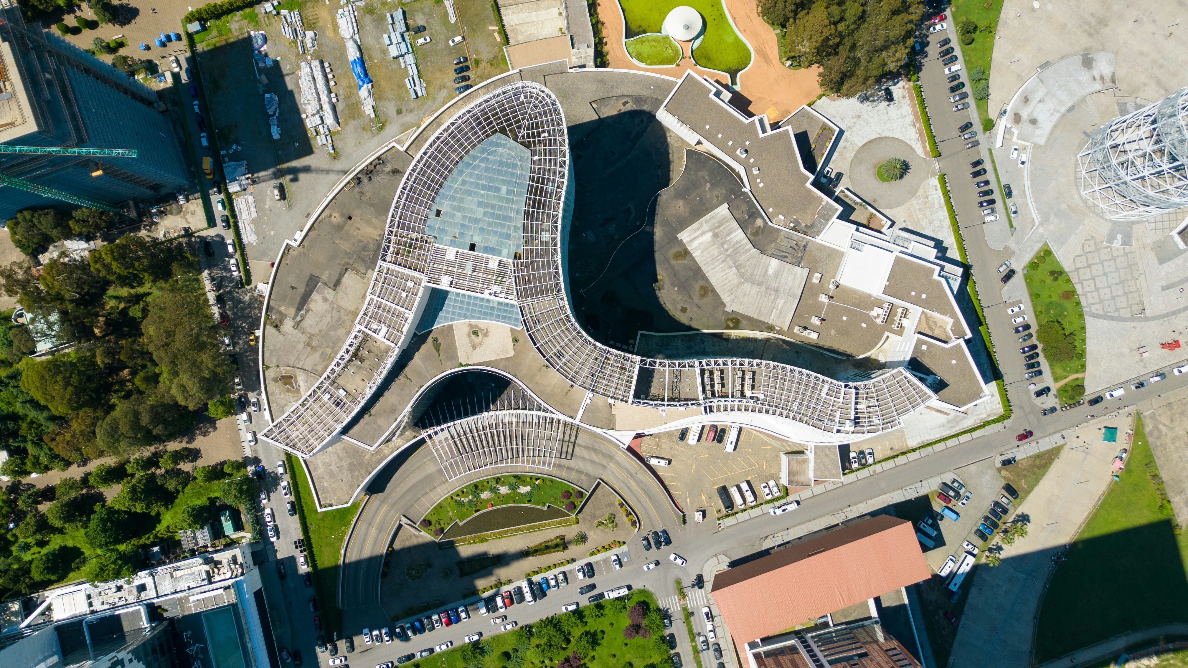 Aerial view of a large, modern, curved building complex.