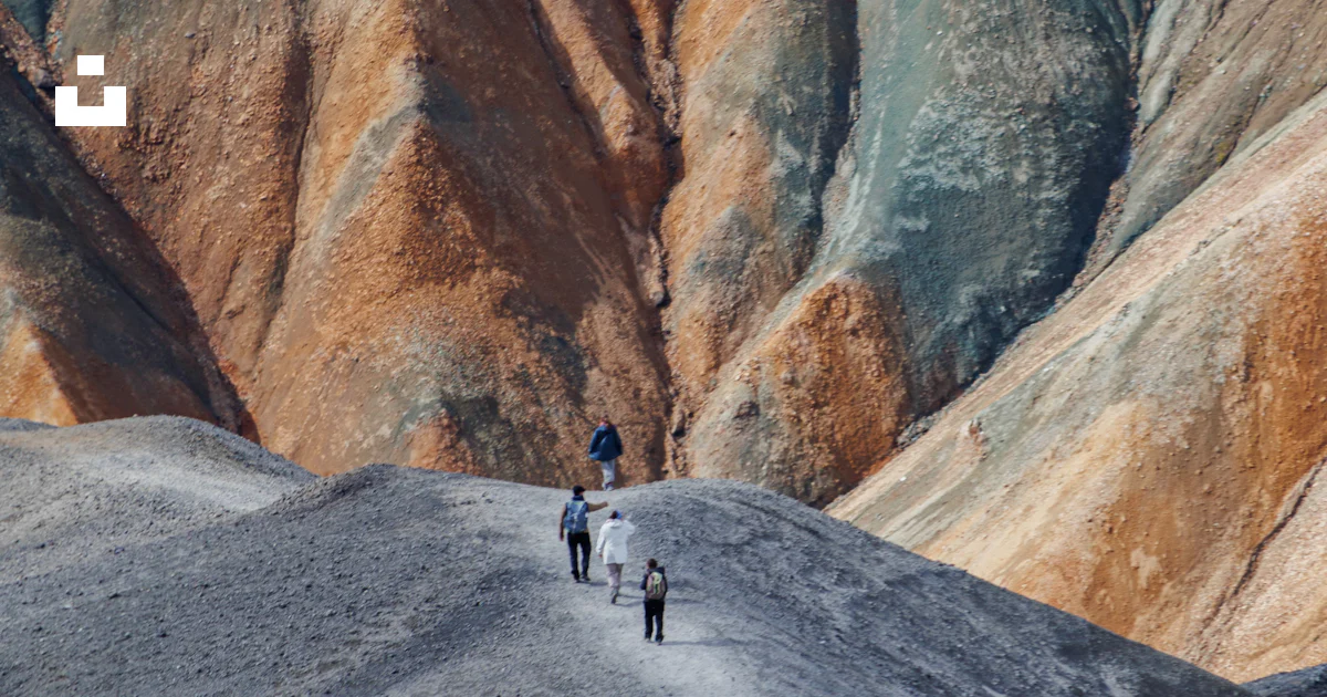 Hikers walk on a path in colorful, rugged mountains. photo – Free ...