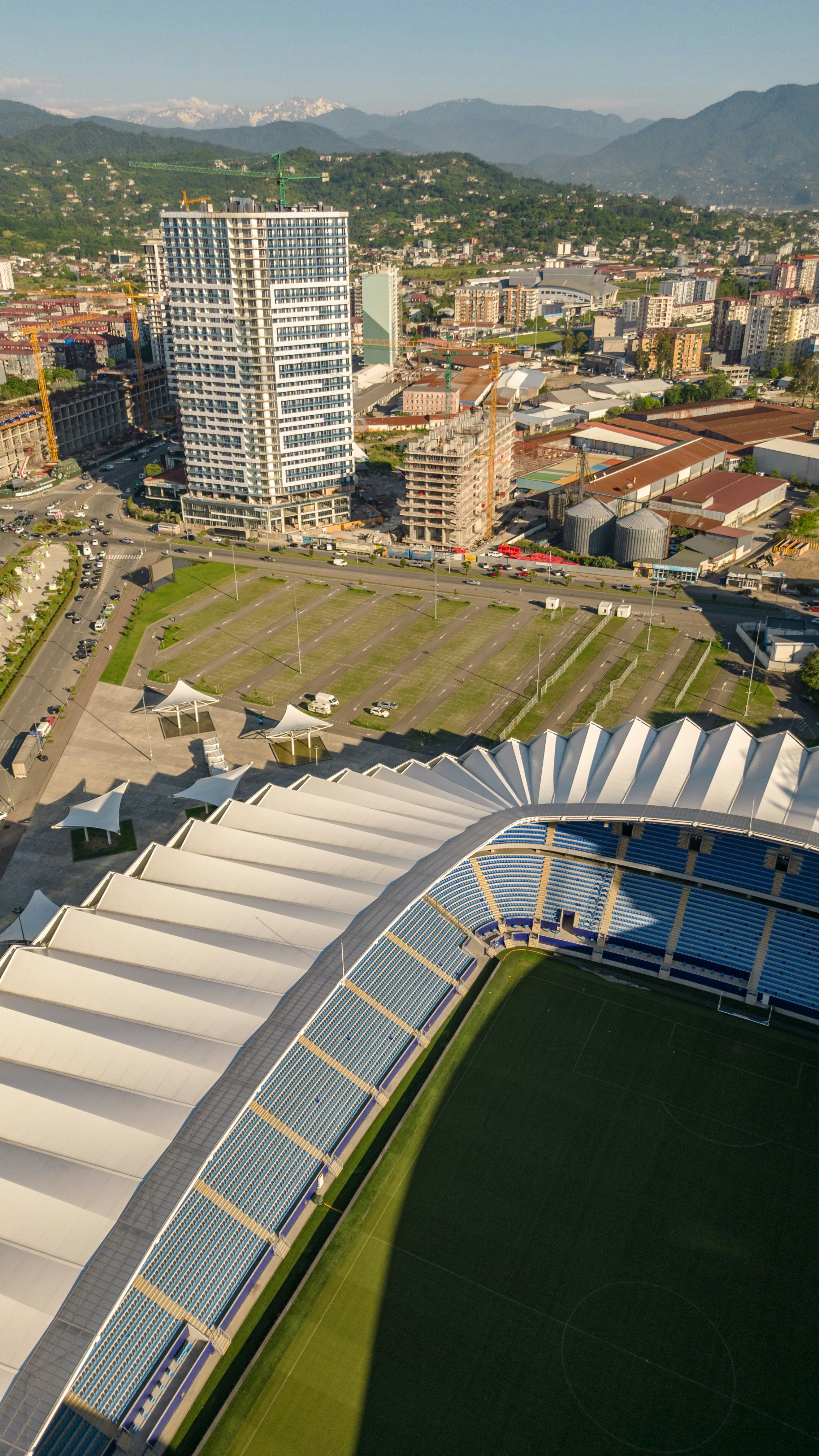 Aerial view of a modern stadium and cityscape