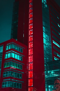 Modern red building with glowing windows at night