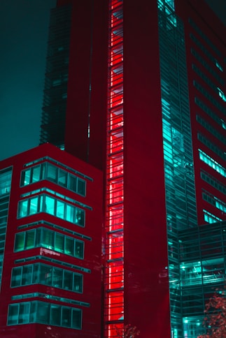 Modern red building with glowing windows at night