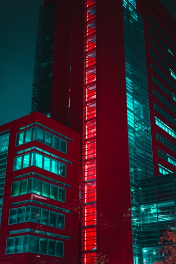 Modern red building with glowing windows at night