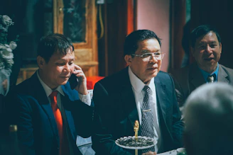 Three men in suits at a formal gathering