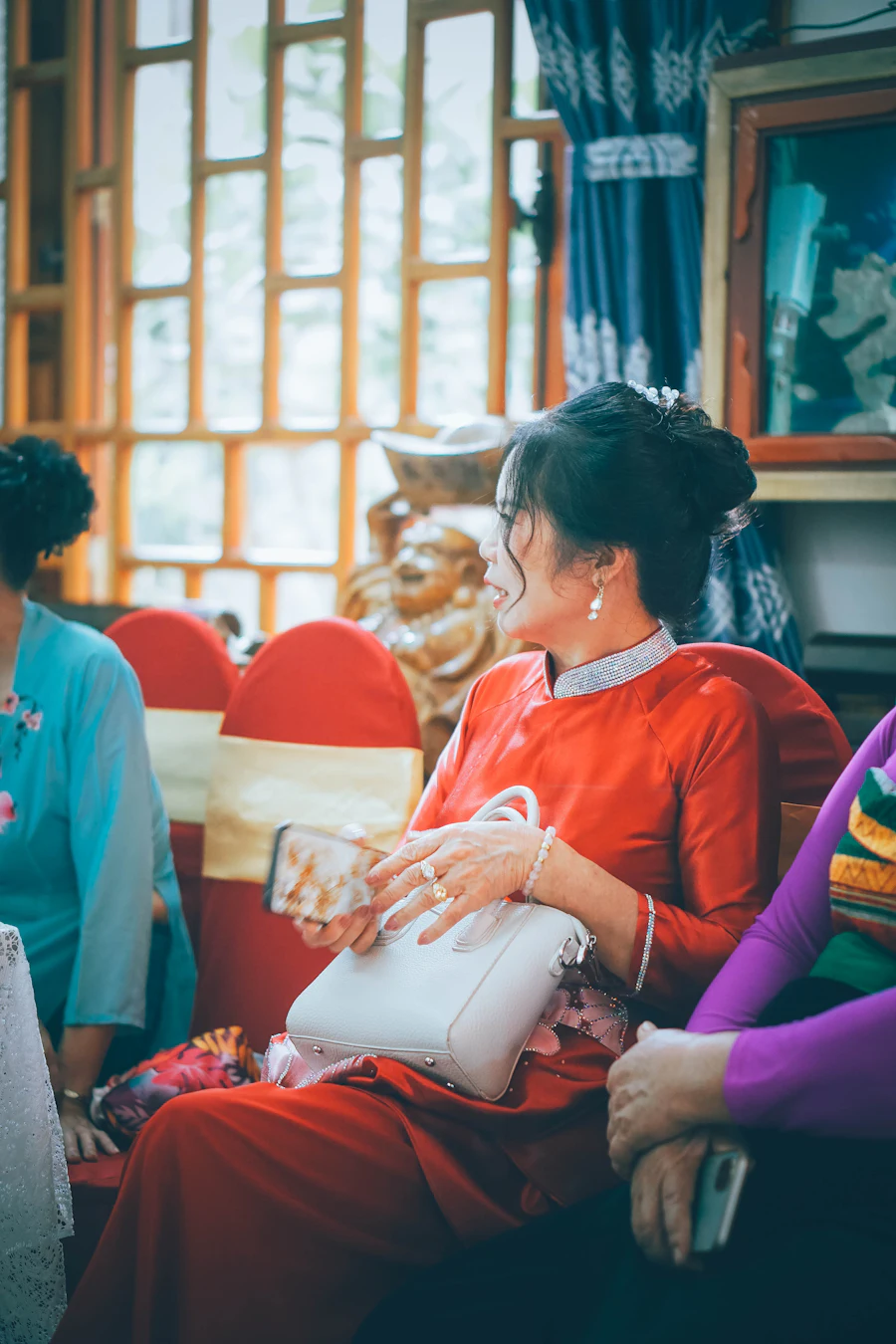 A customer in red holding a white bag