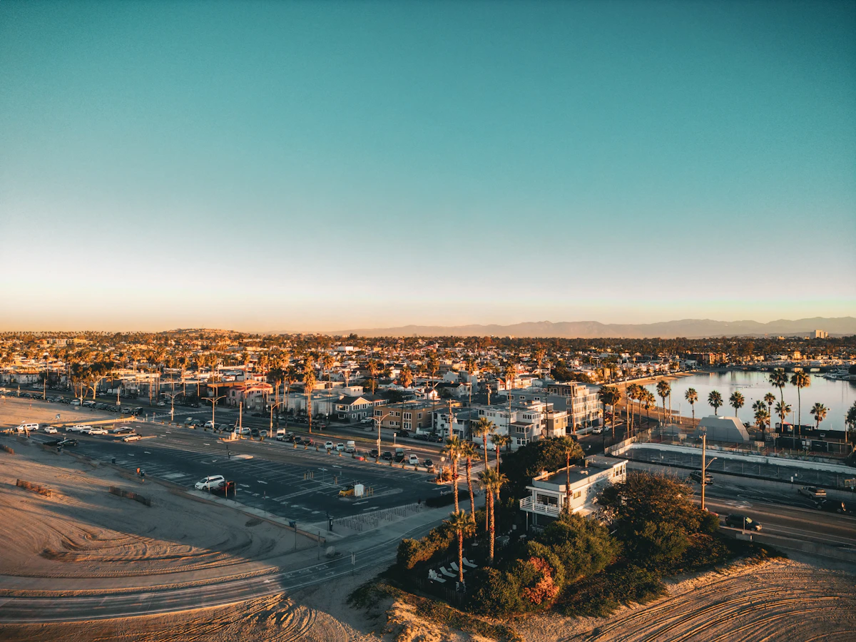 Aerial view of Naples Island in Long Beach, California showing waterfront canal homes, palm trees, and the coastal neighborhood from above