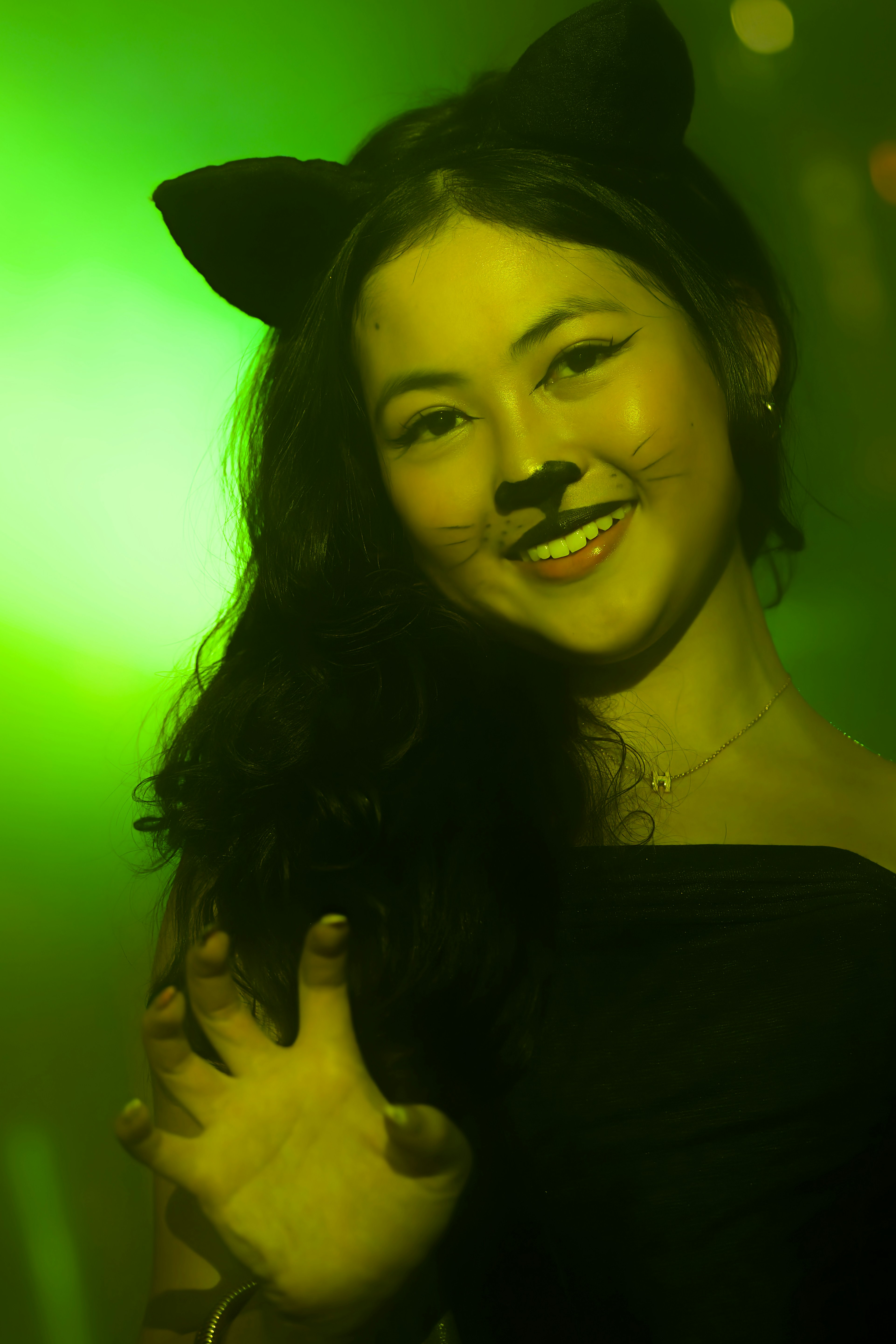 Woman in cat costume with green lighting