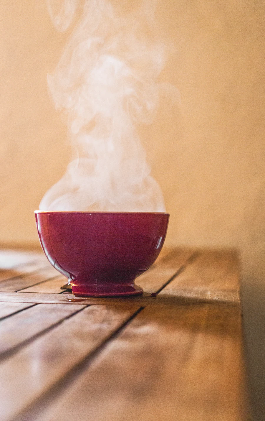 Steaming bowl on a wooden table