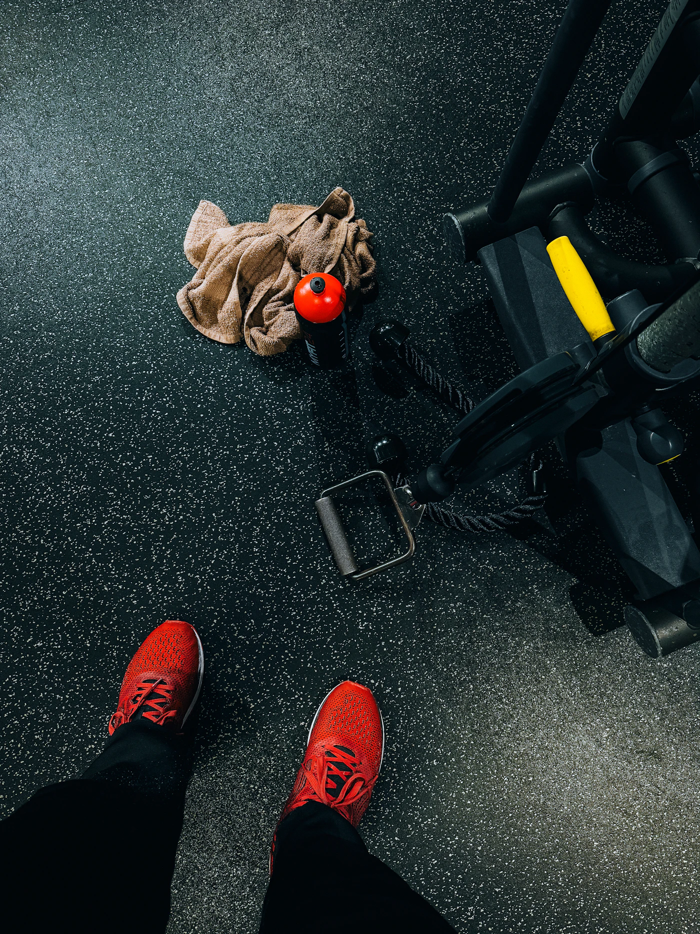 Close-up of gym equipment and training shoes on the floor