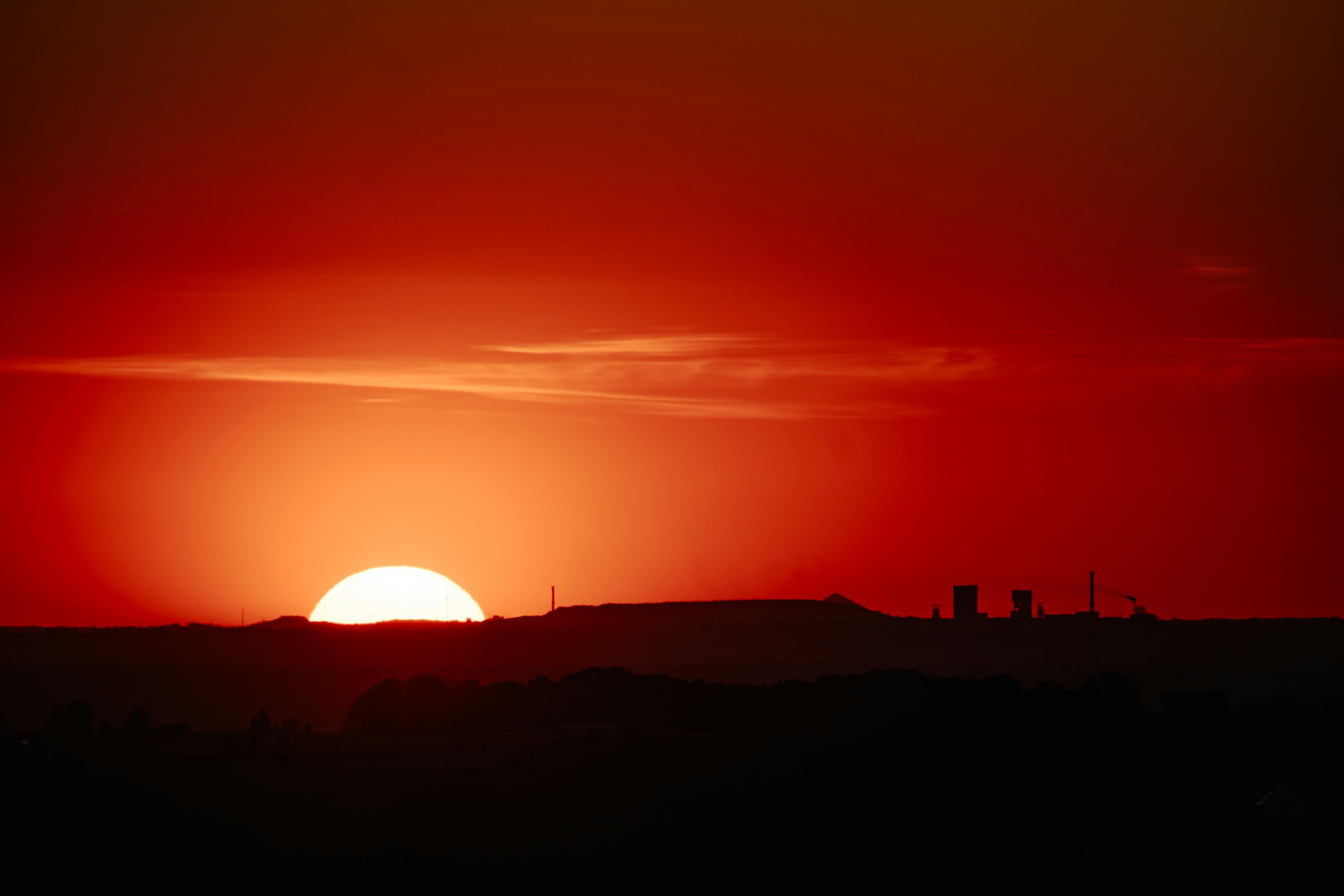 Vibrant sunset over a silhouetted landscape