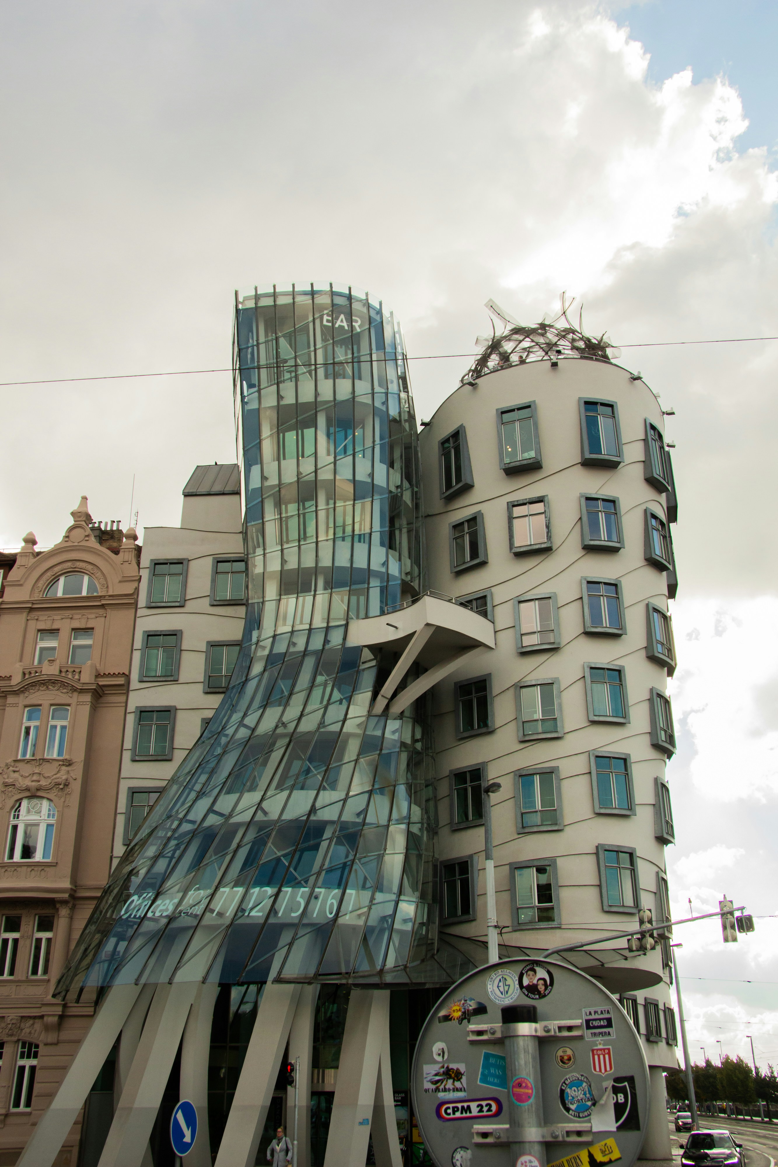 Modern glass building next to older architecture.