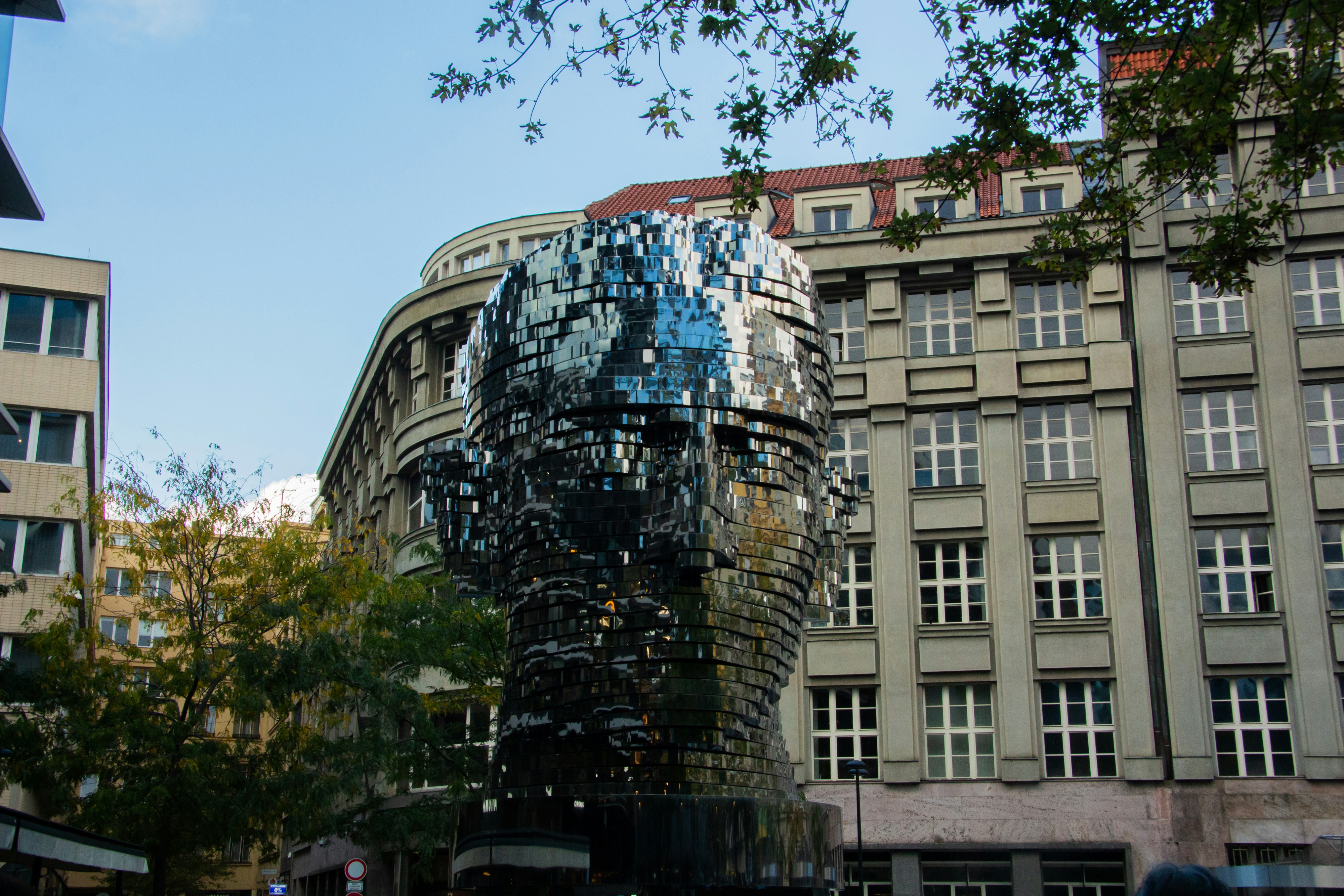 Sculpture of a head made of reflective pieces.