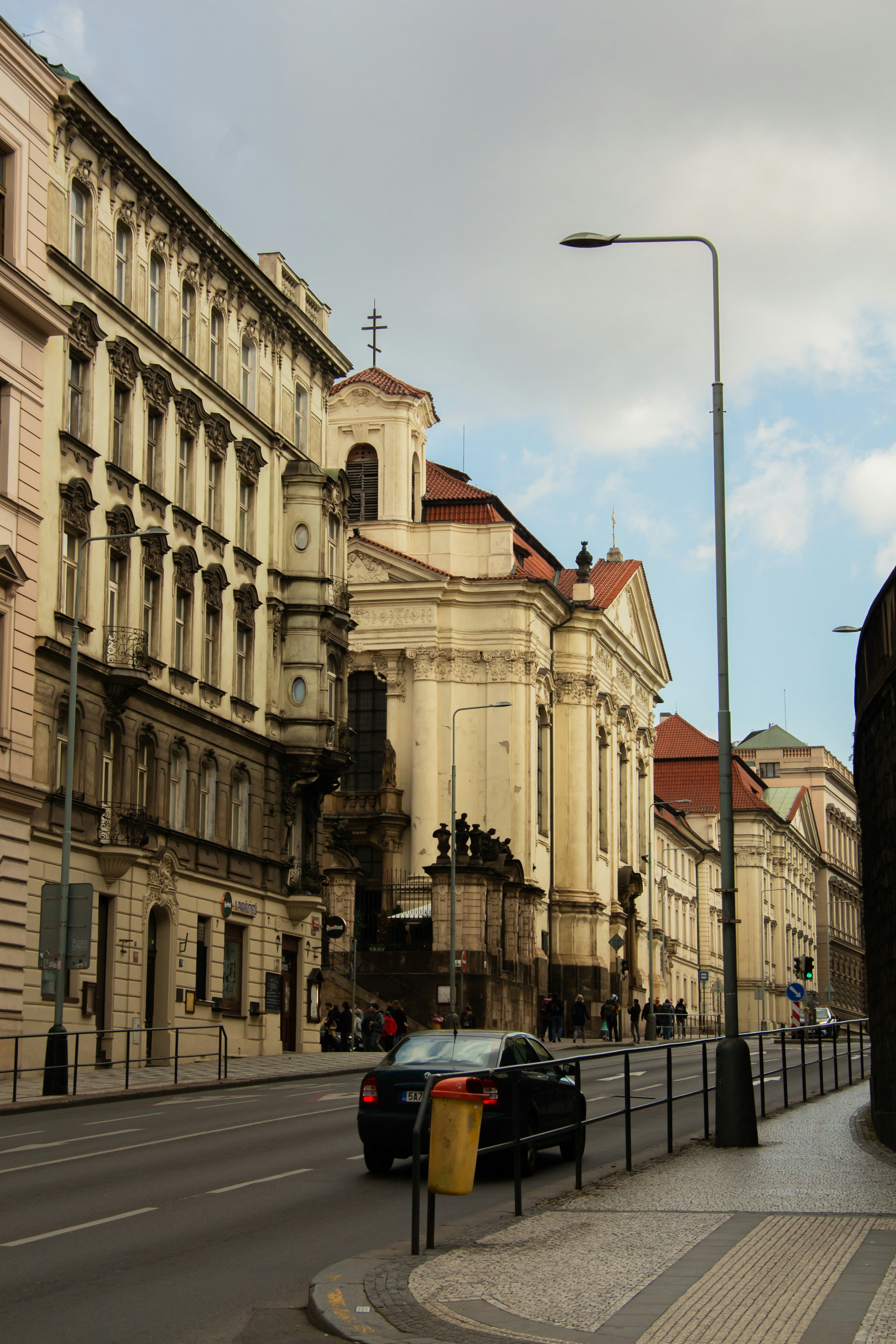 Street view of old european buildings with a car.