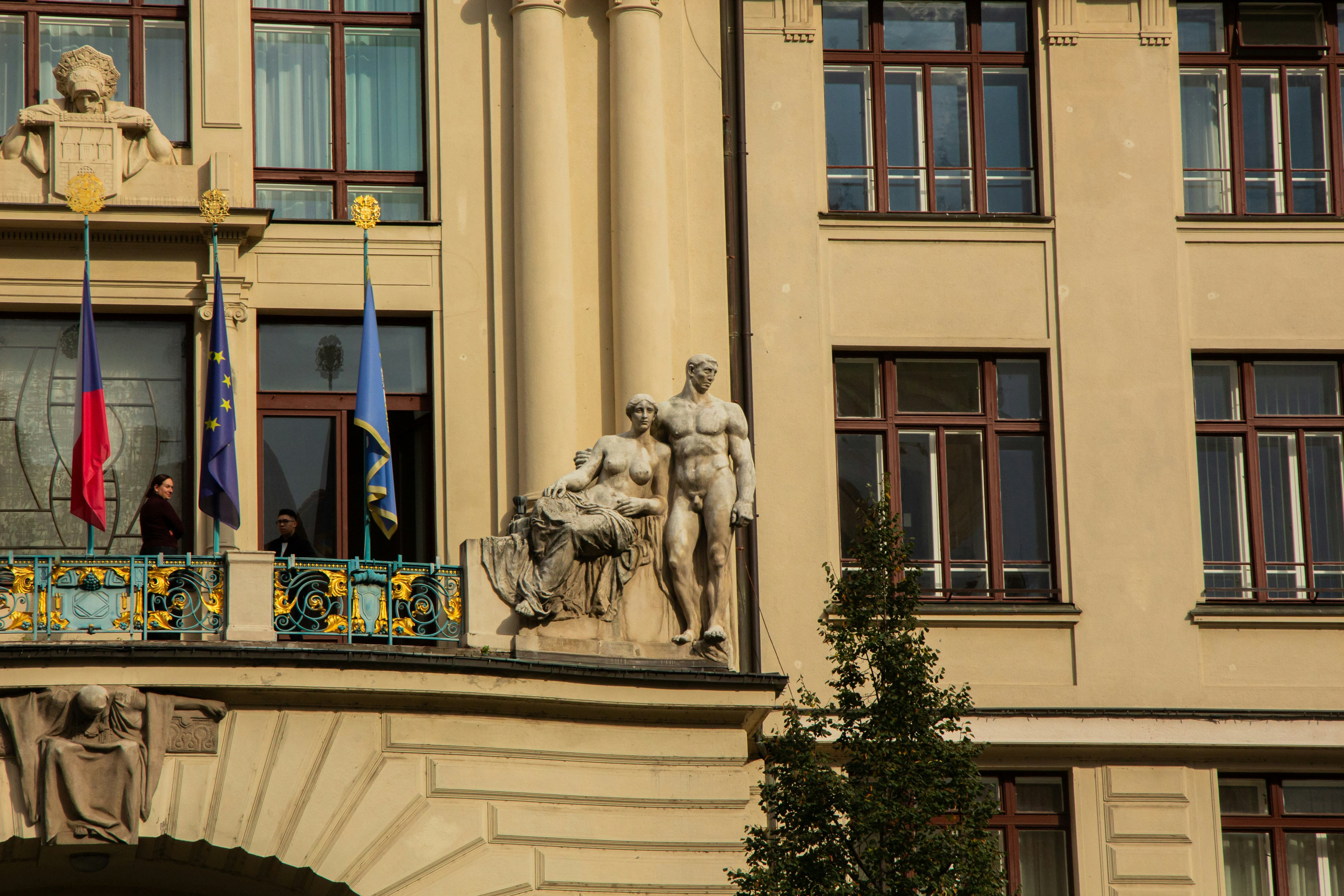 Ornate building facade with statues and flags