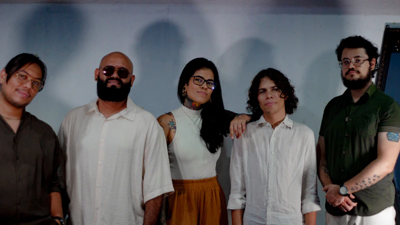 five people posing for a group photo