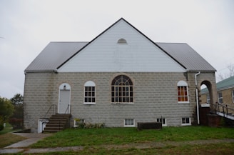 A stone building with a large arched window.