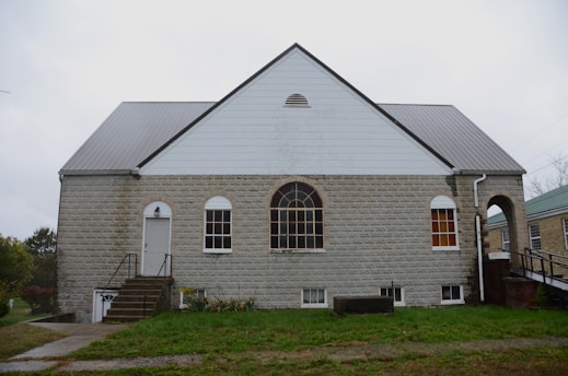 A stone building with a large arched window.