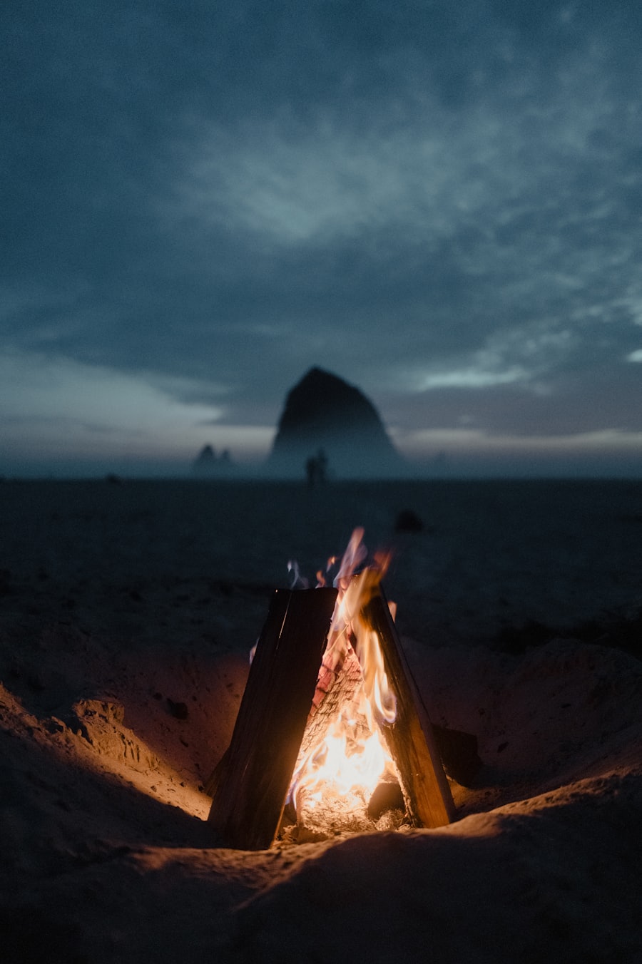 Fire glow on a dark beach at dusk