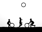 Children playing with hoops against a bright sky