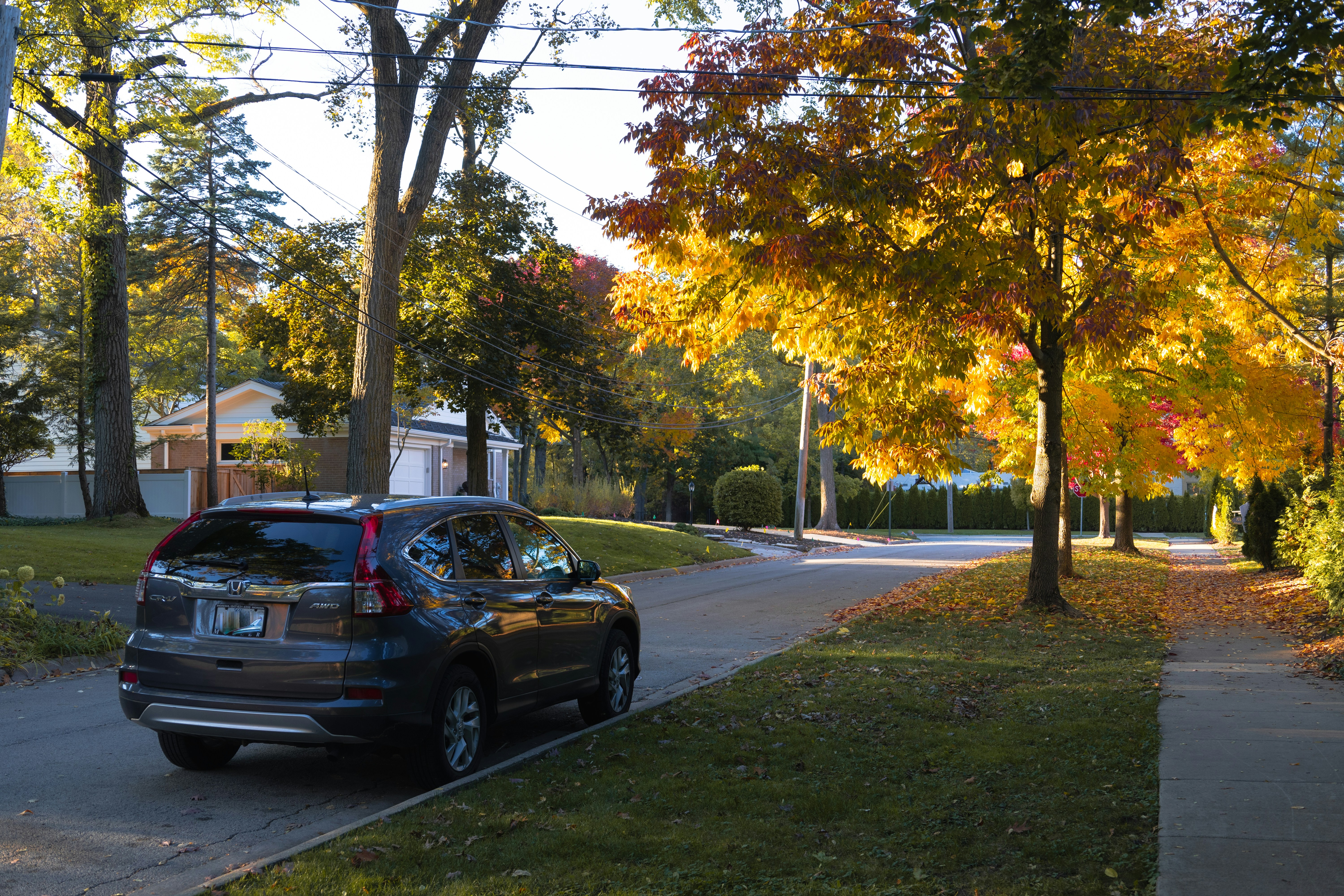 Family loading bags into a pre-owned SUV in a suburban driveway