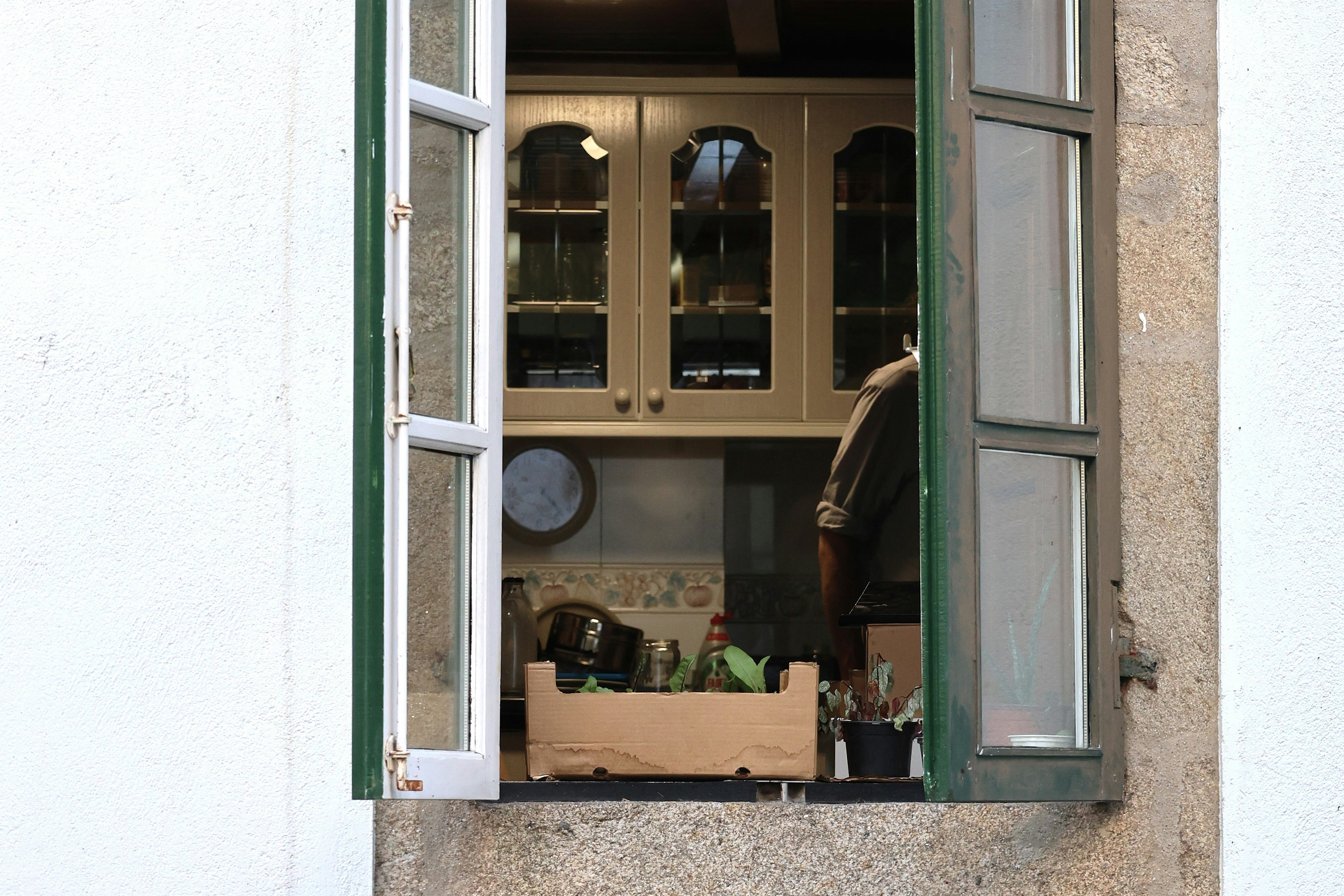 View into a kitchen through an open window.