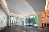 Modern yoga studio with large windows and natural light.