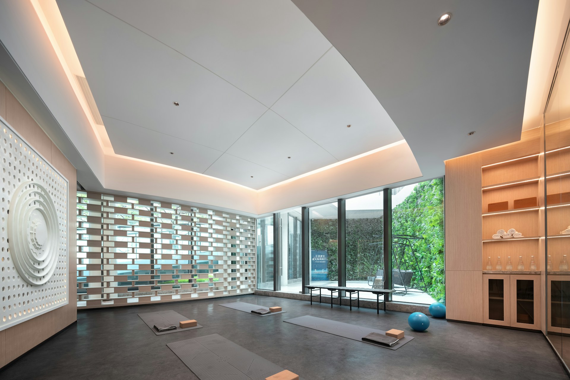 Modern yoga studio with large windows and natural light.