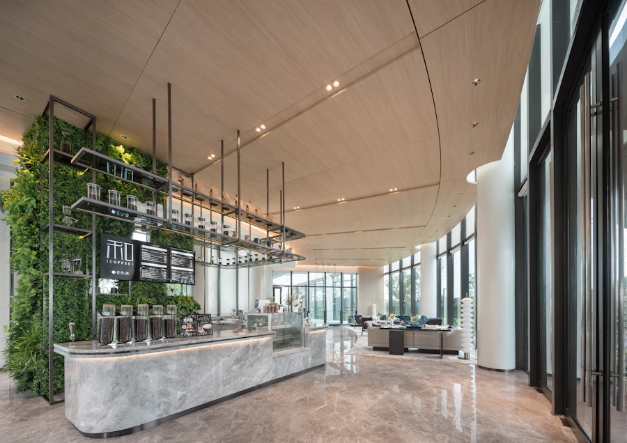 A modern coffee shop with a plant wall and counter