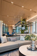 Modern living room with comfortable sofa and lush green wall.