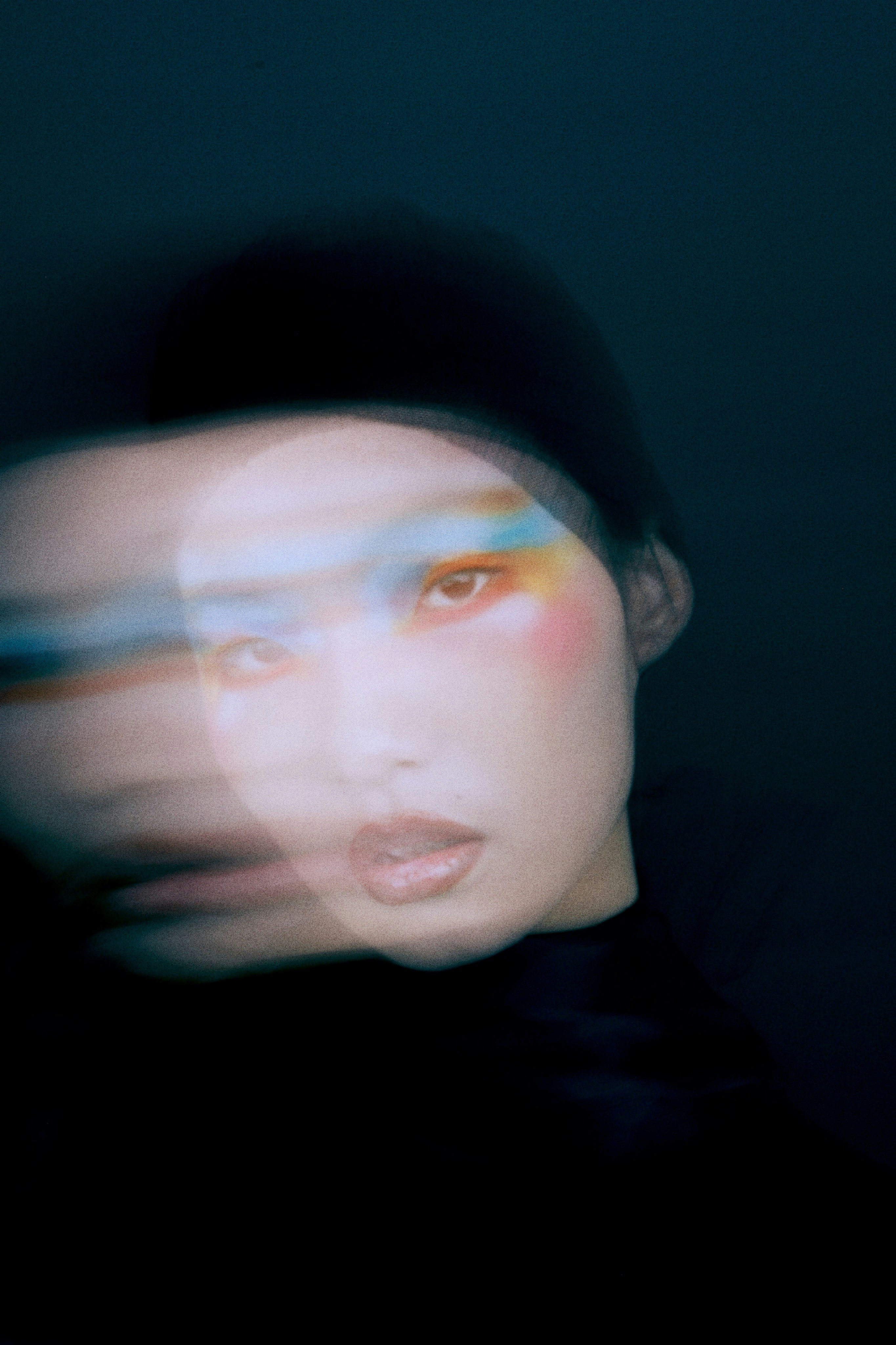 Woman with colorful makeup and blurred face