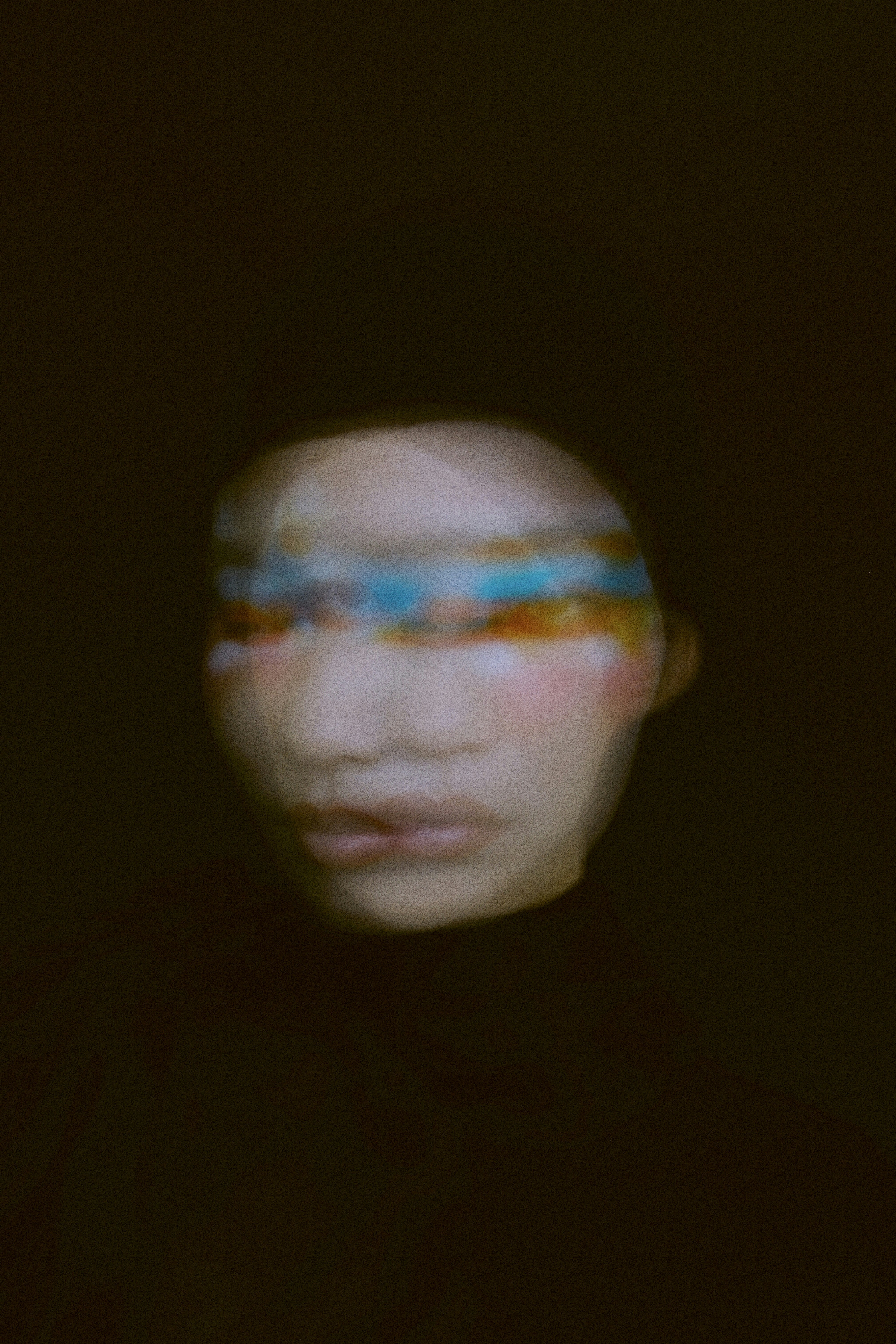 Abstract face with colorful stripes across eyes