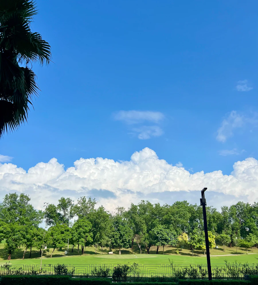 Lush green golf course under a blue sky