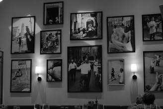 Collection of framed black and white photographs on wall