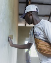 Man plastering a wall with a trowel.