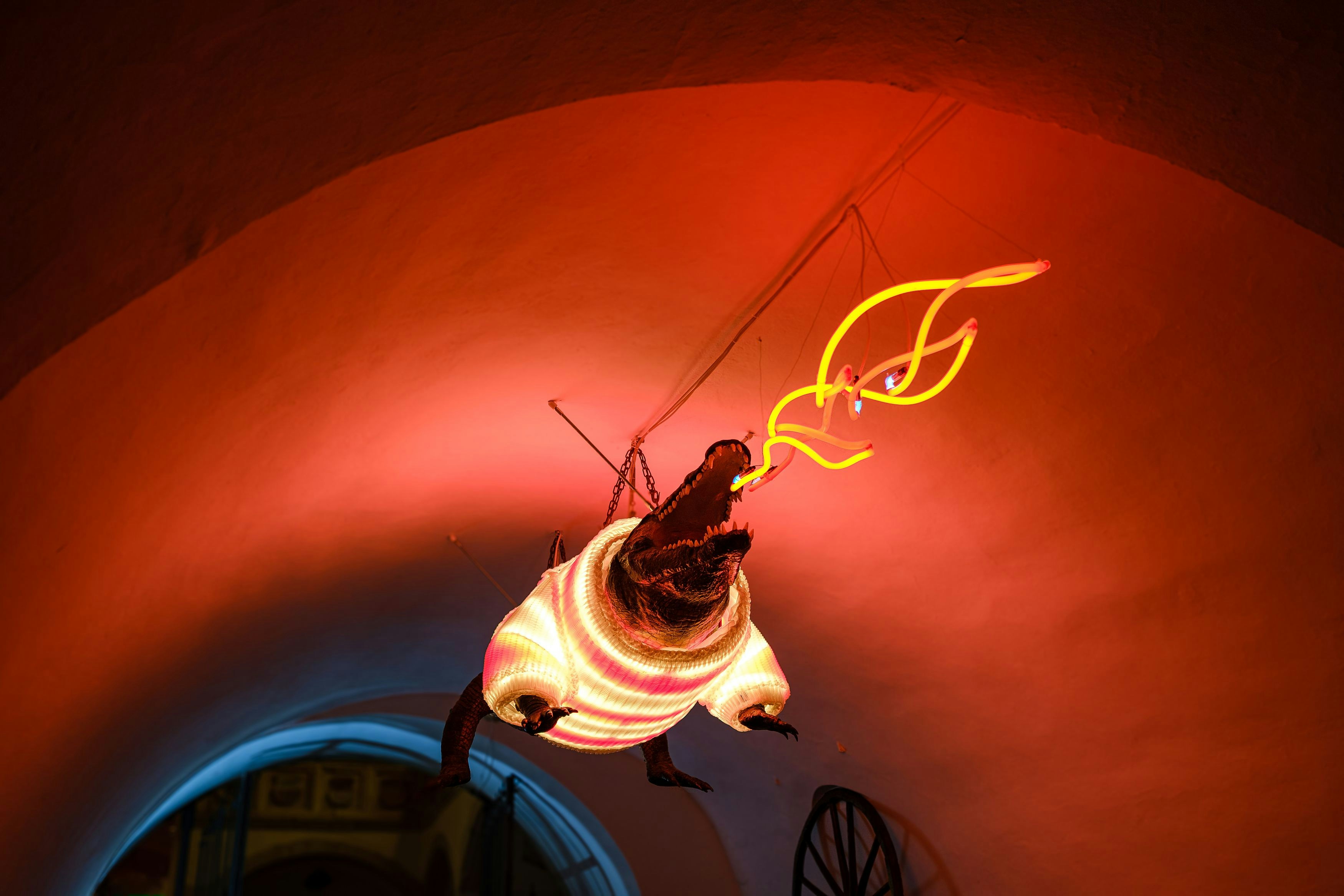 A creature with glowing red eyes and a white shirt.