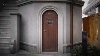 A dark wooden door with a hexagonal window.