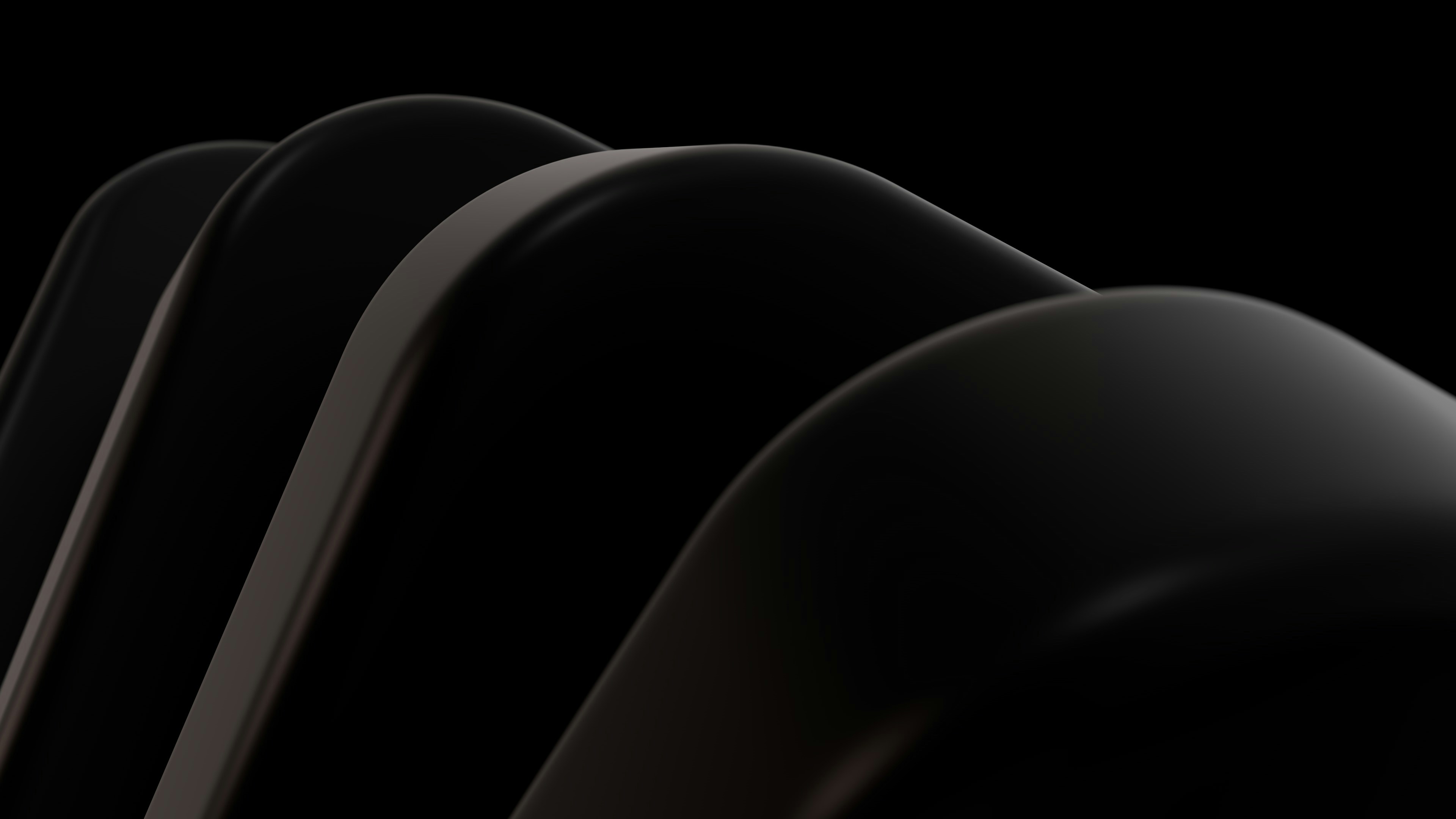 Dark, curved shapes against a black background