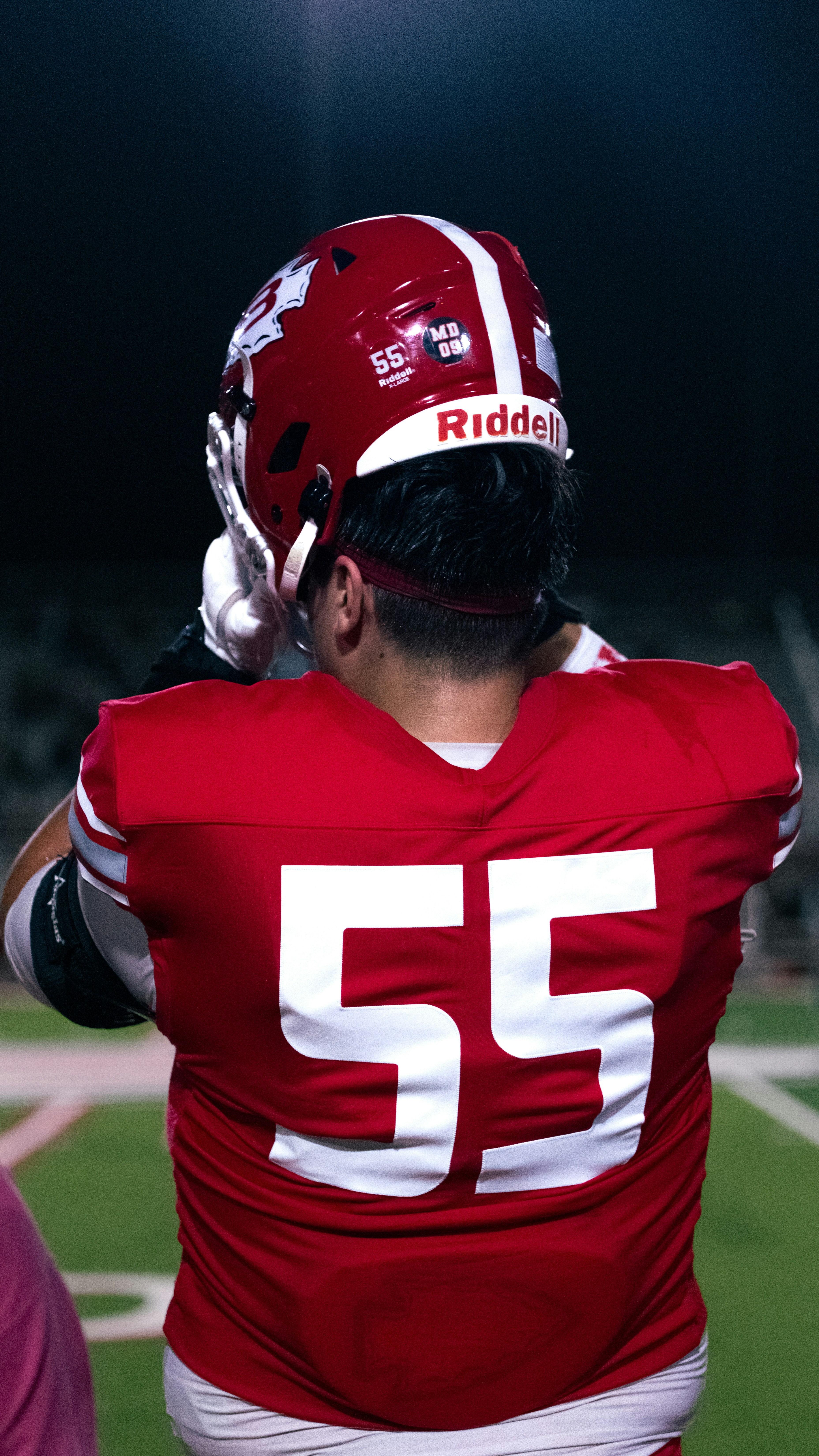 Football player in red jersey with number 55