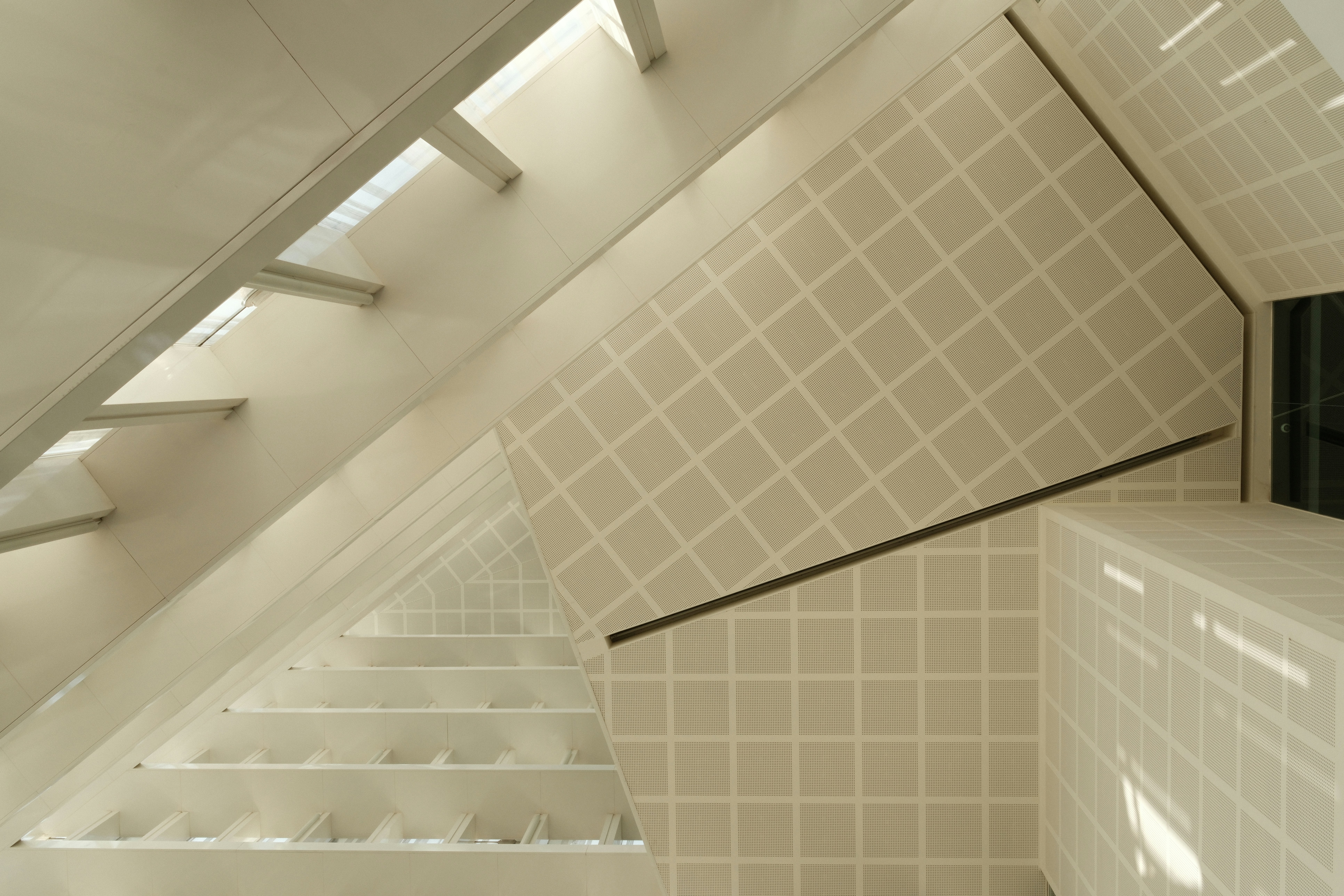 Modern staircase with patterned wallpaper and railing