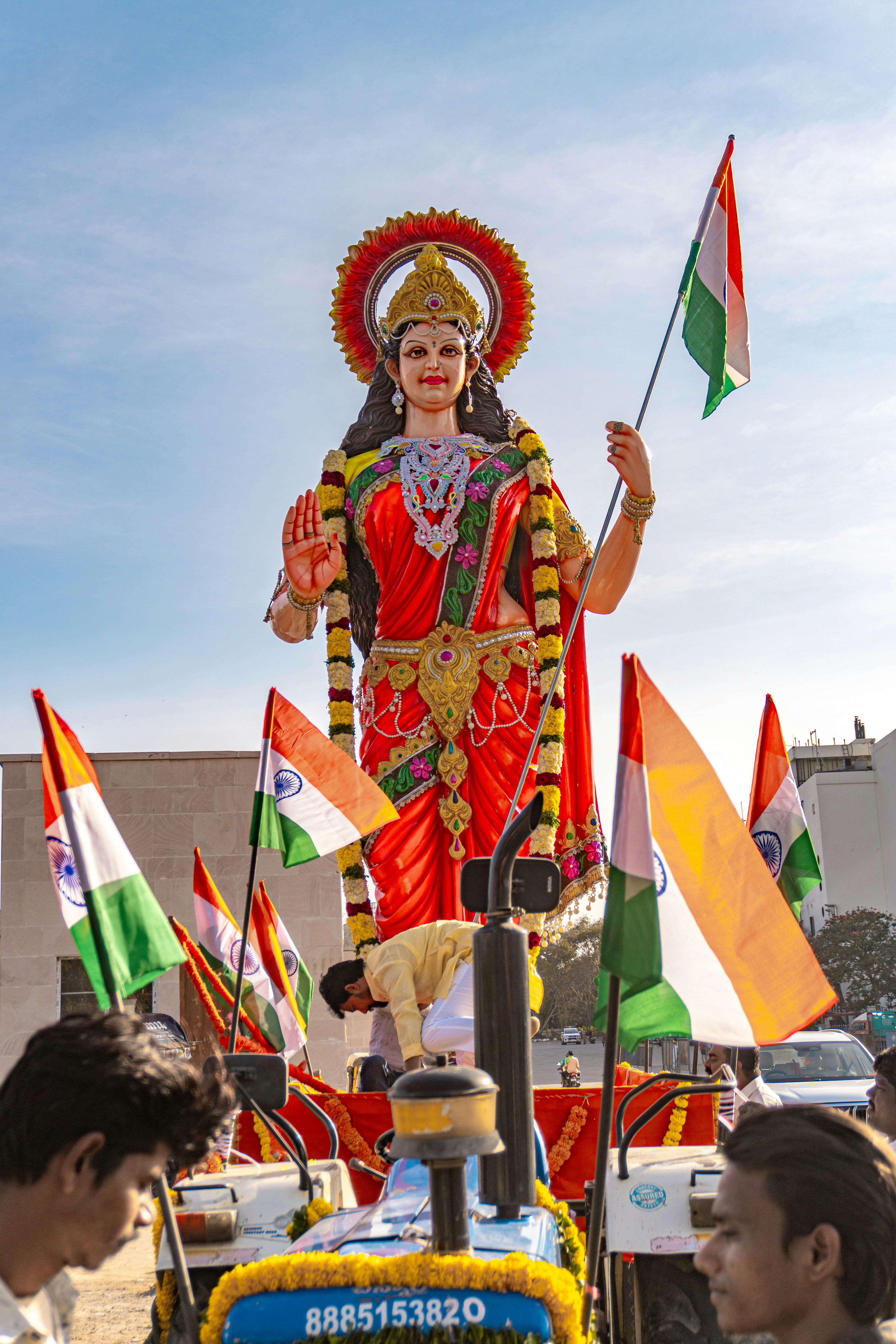 A statue of a goddess decorated with indian flags