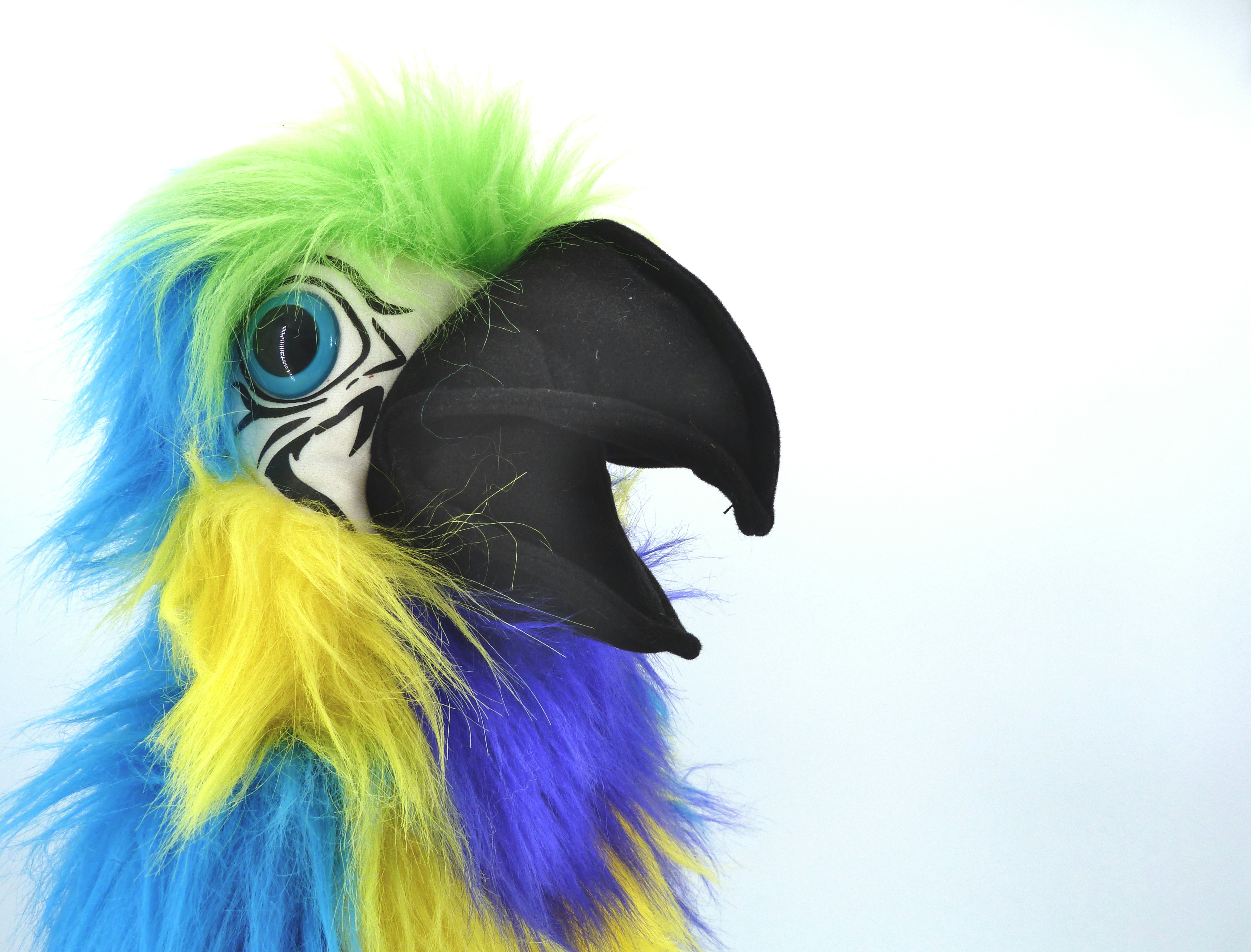 A colorful parrot puppet with open beak