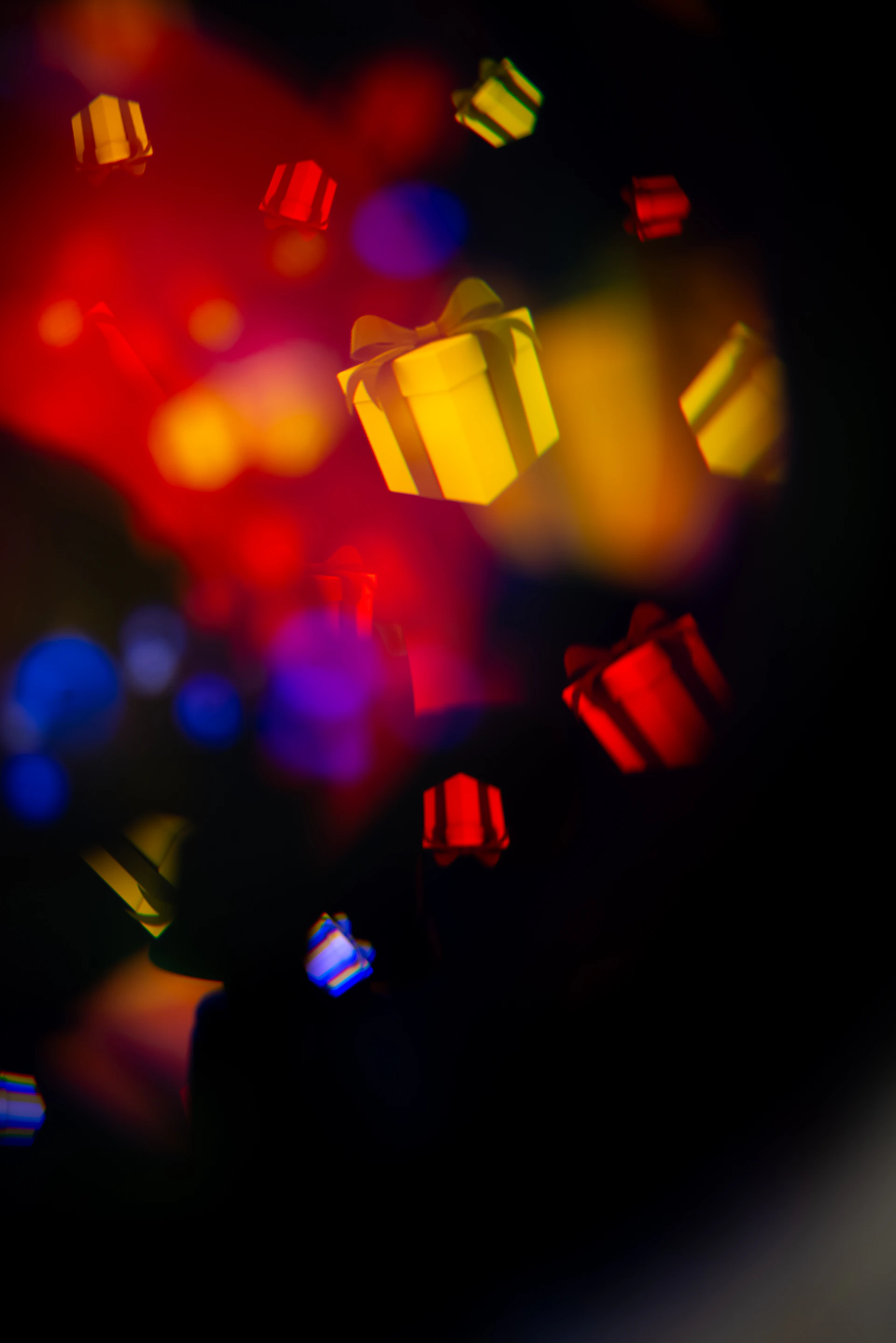 Colorful gift boxes falling against a dark background