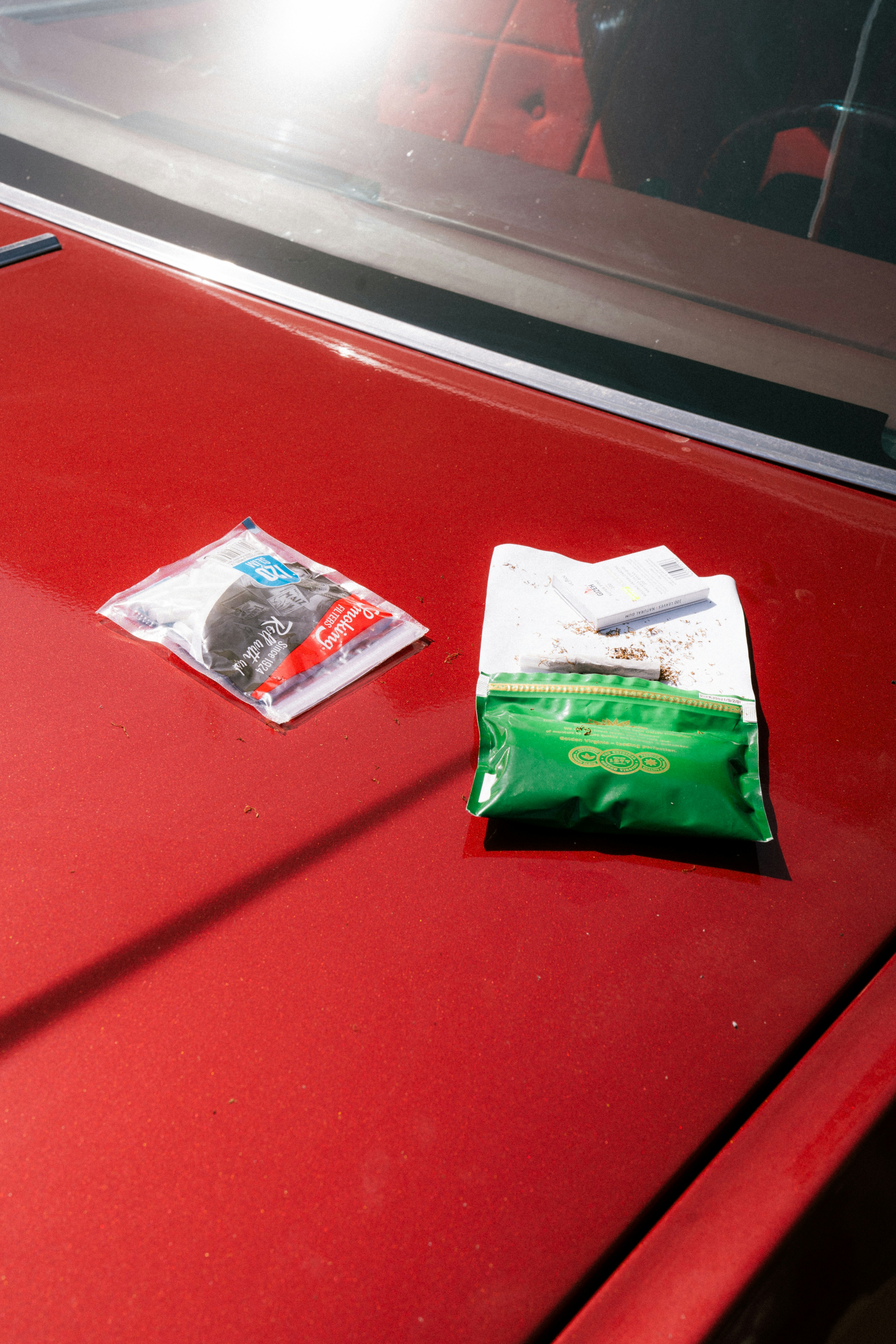 Two small packages on a red surface.