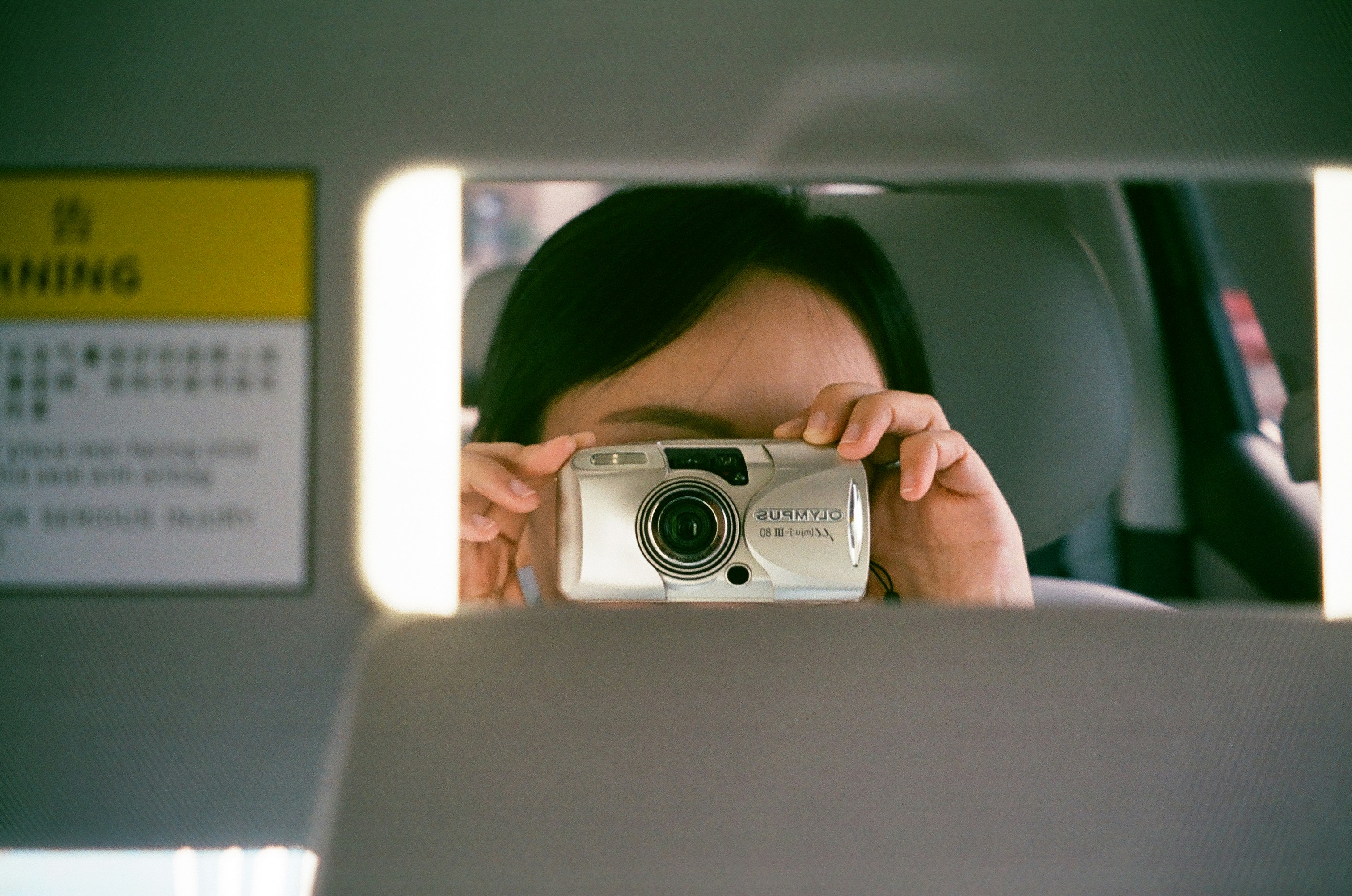 Person takes a selfie with a vintage camera.