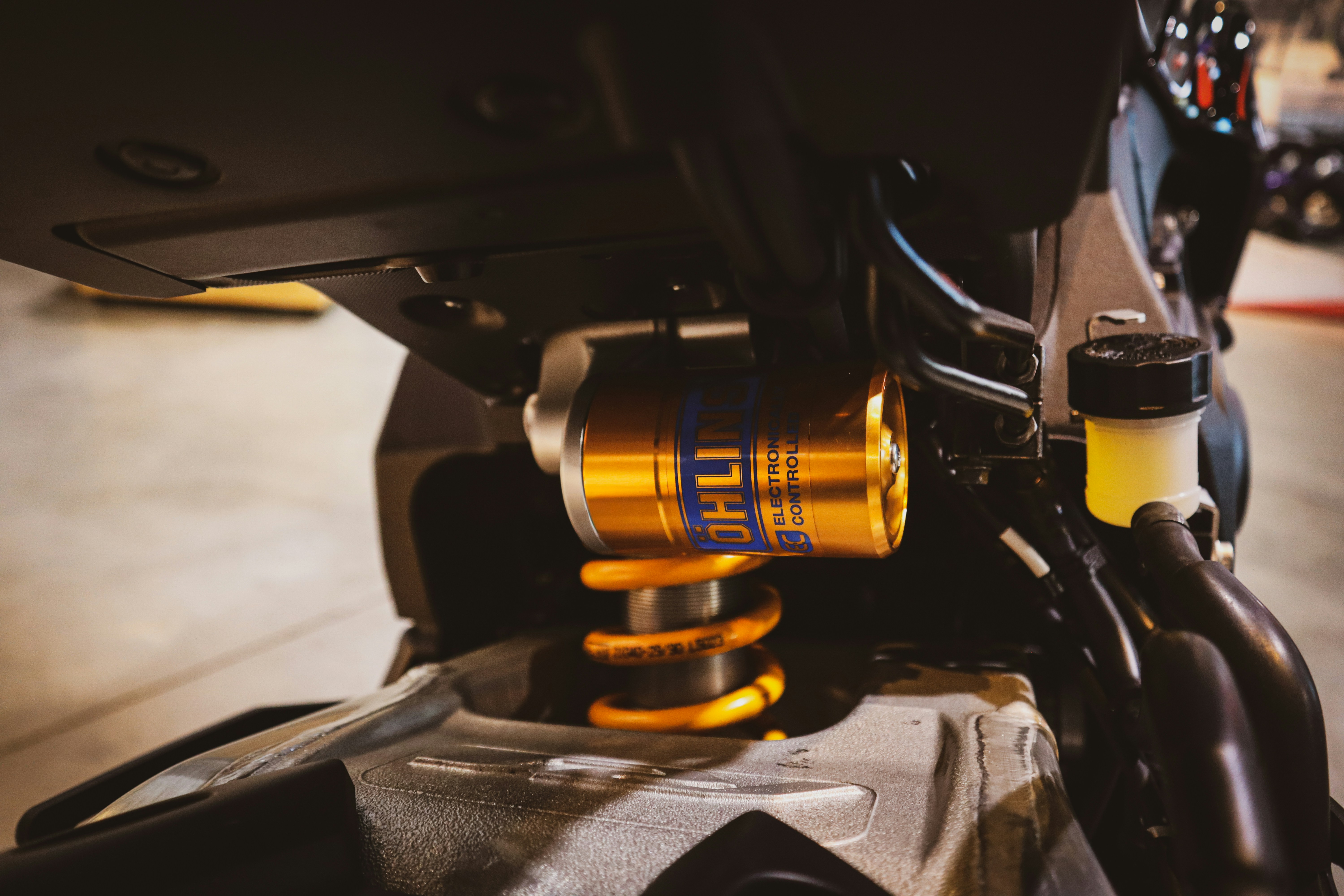 Golden motorcycle suspension with yellow spring detail