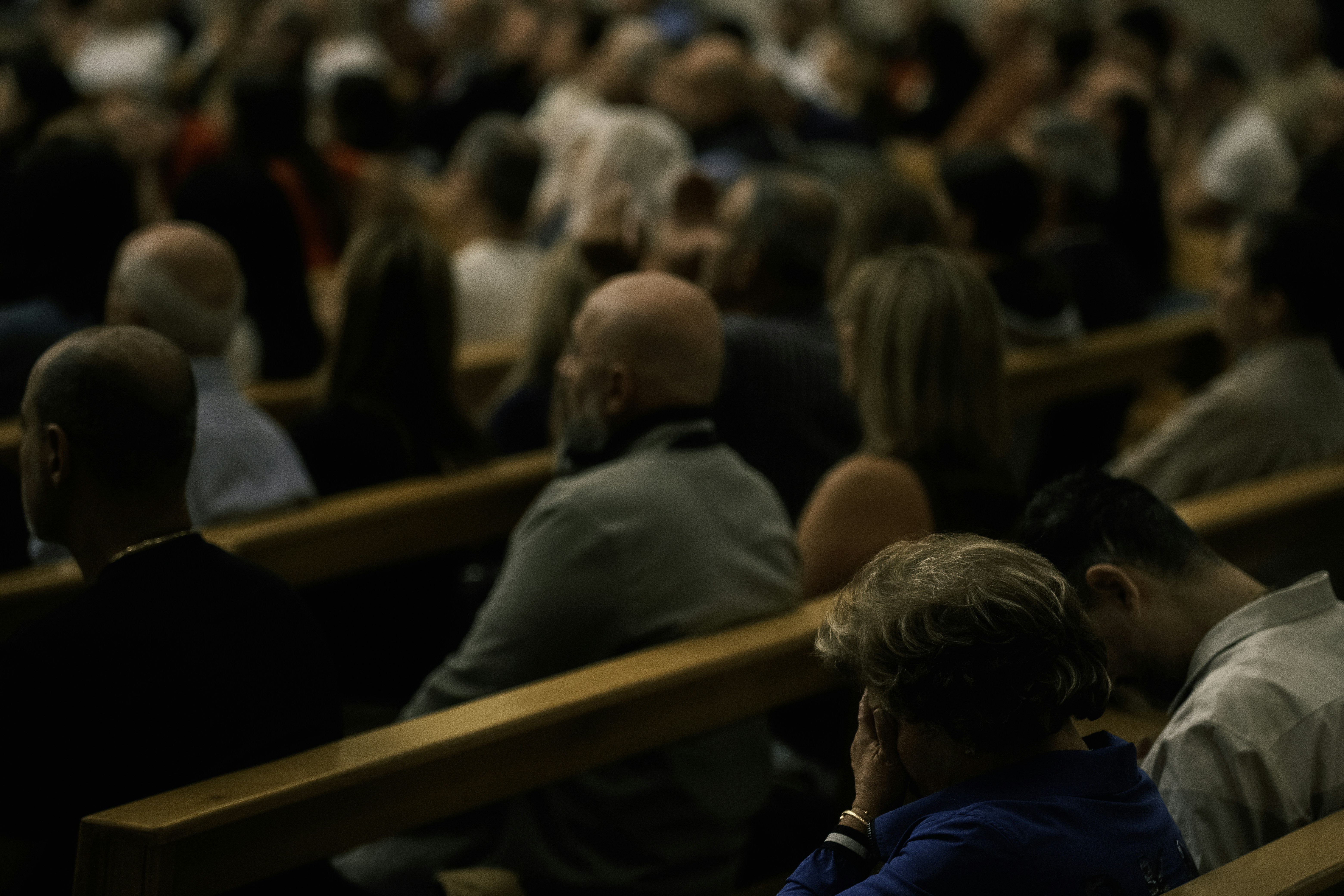 Audience seated in a dimly lit hall