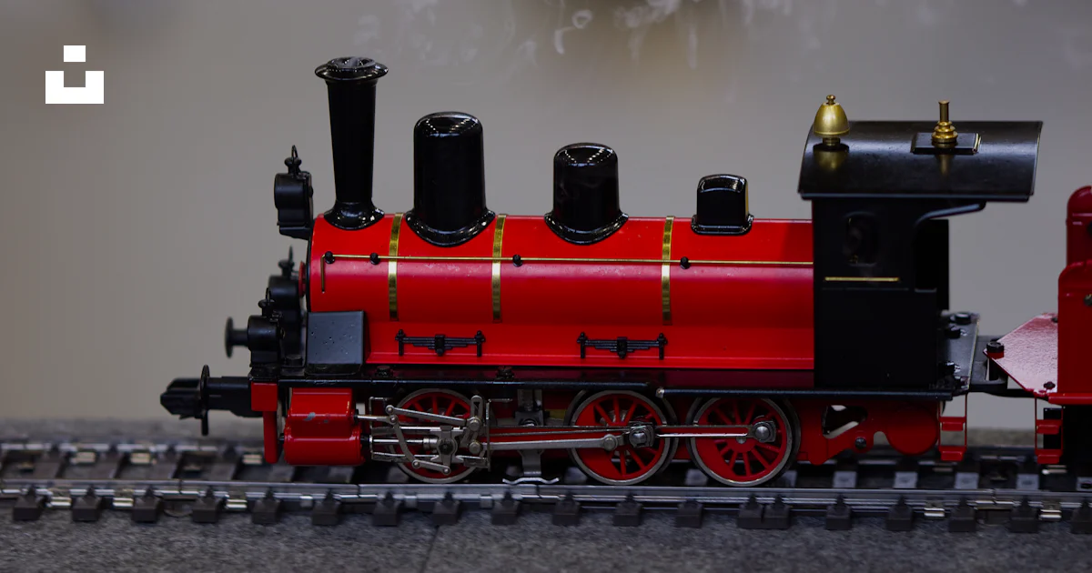Red Model Train A red model steam train on tracks photo – Free Smoke Image on Unsplash