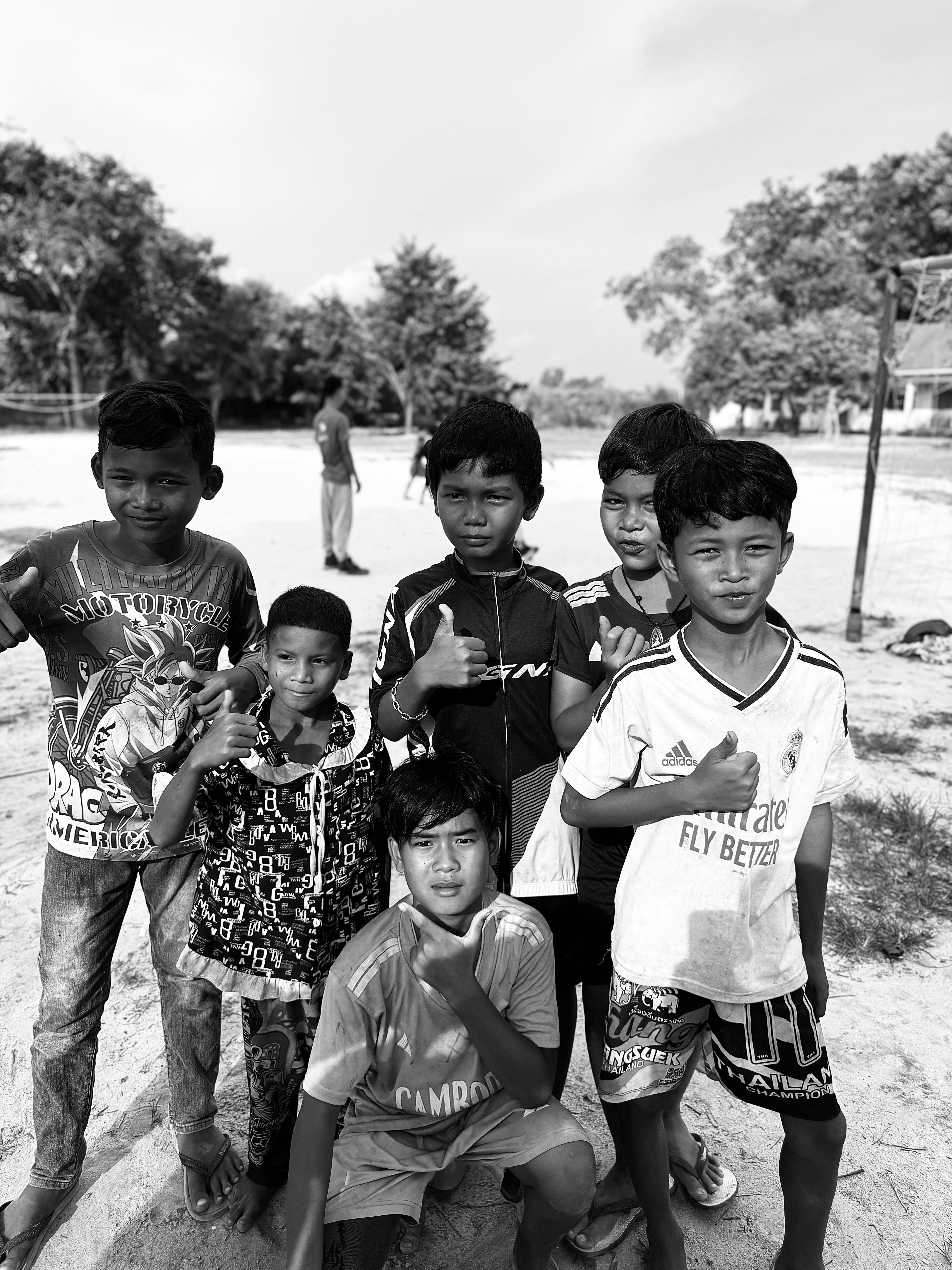 Group of boys giving thumbs up outdoors