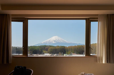 Snow-capped mountain seen through a hotel window