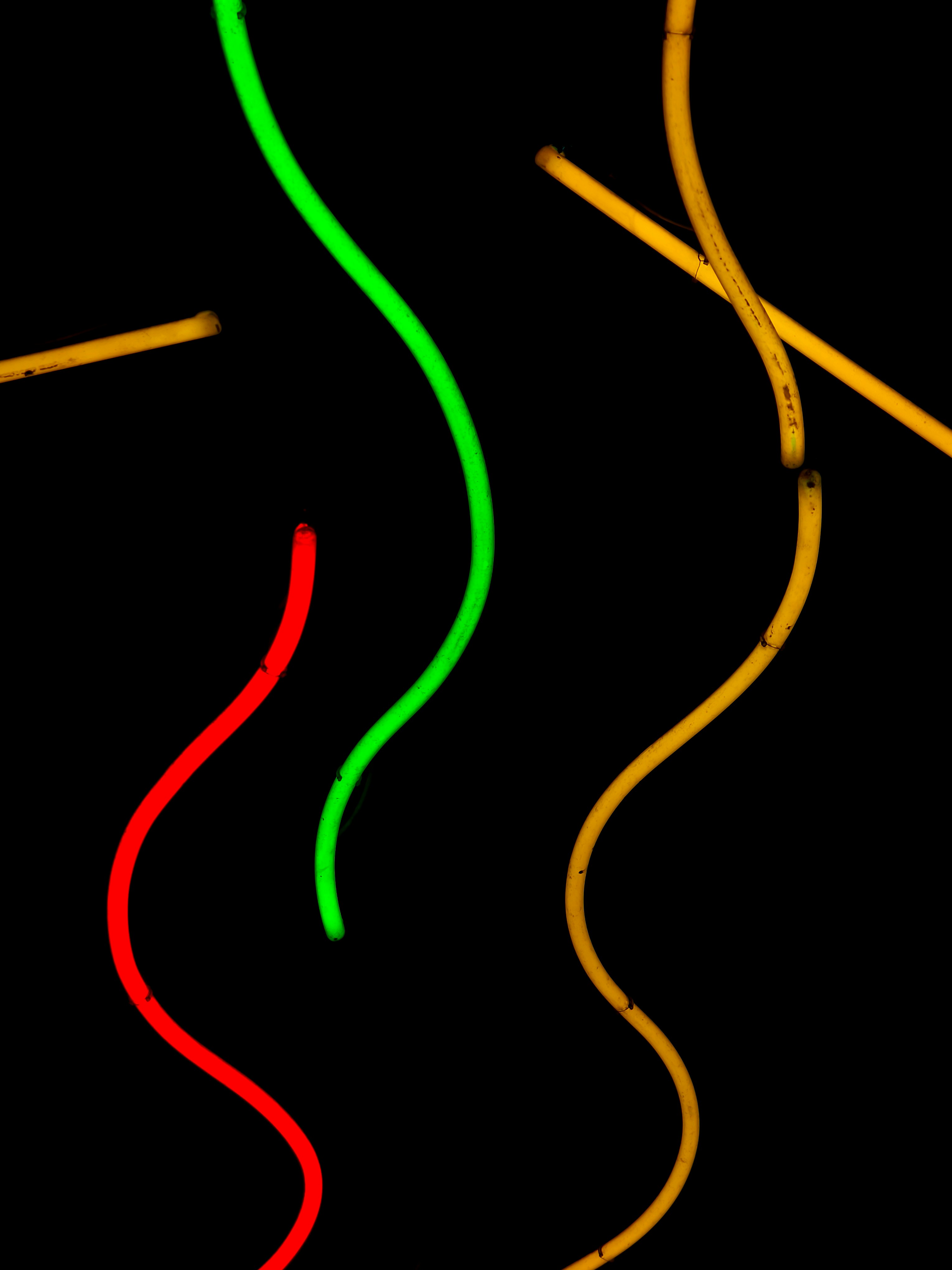 Three colorful neon tubes on black background