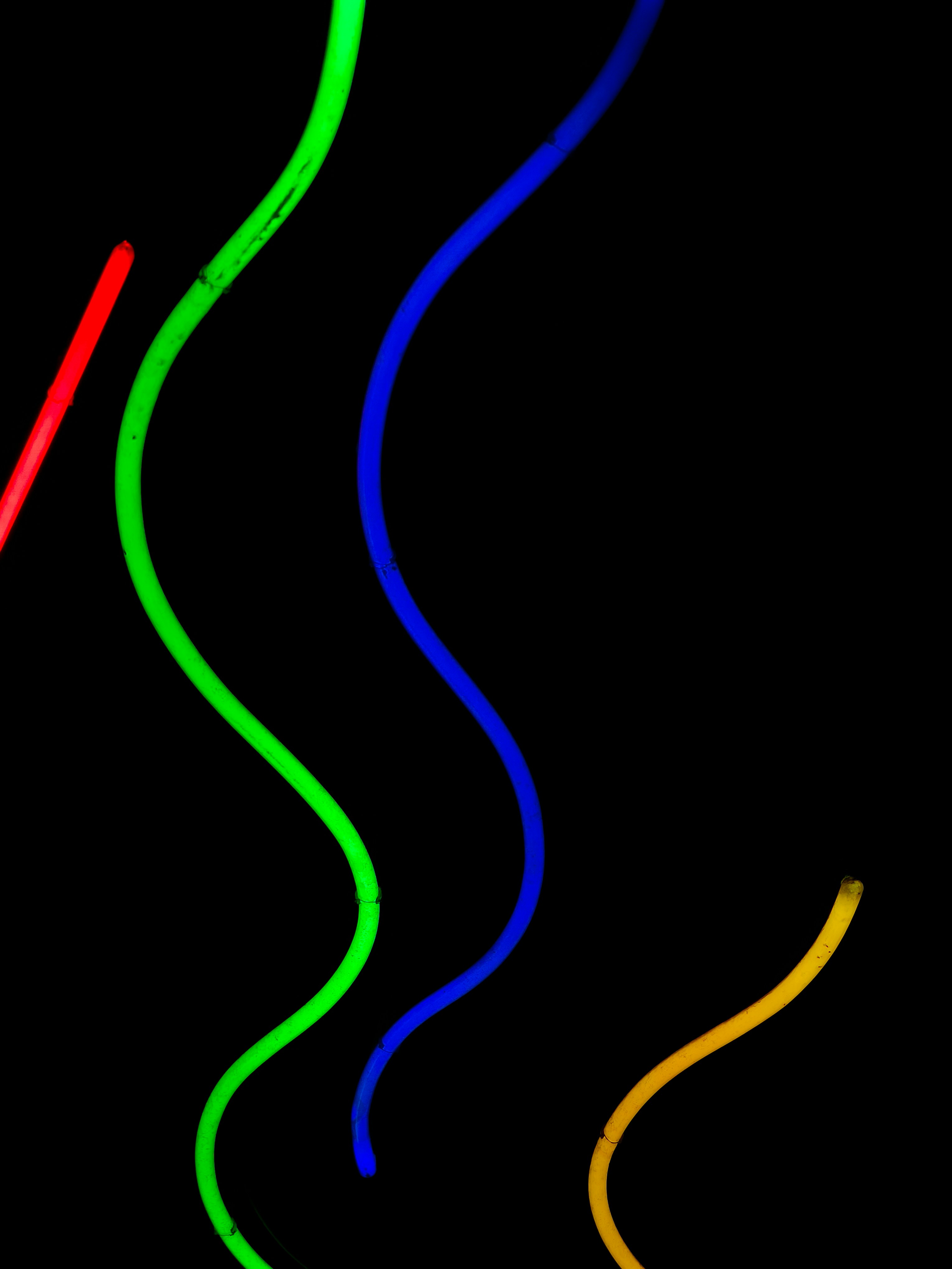 Colorful glowing tubes on black background